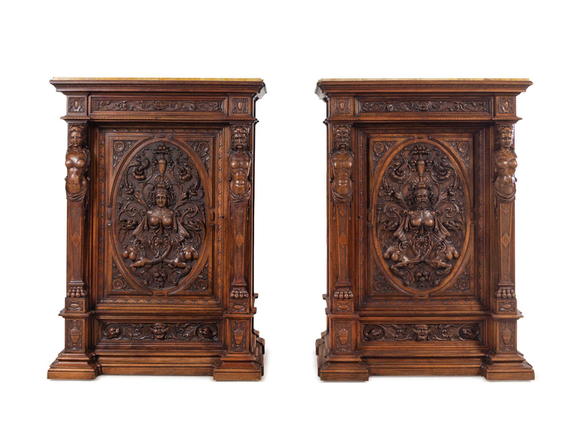 A Pair of Renaissance Revival Carved Walnut Marble-Top Cabinets