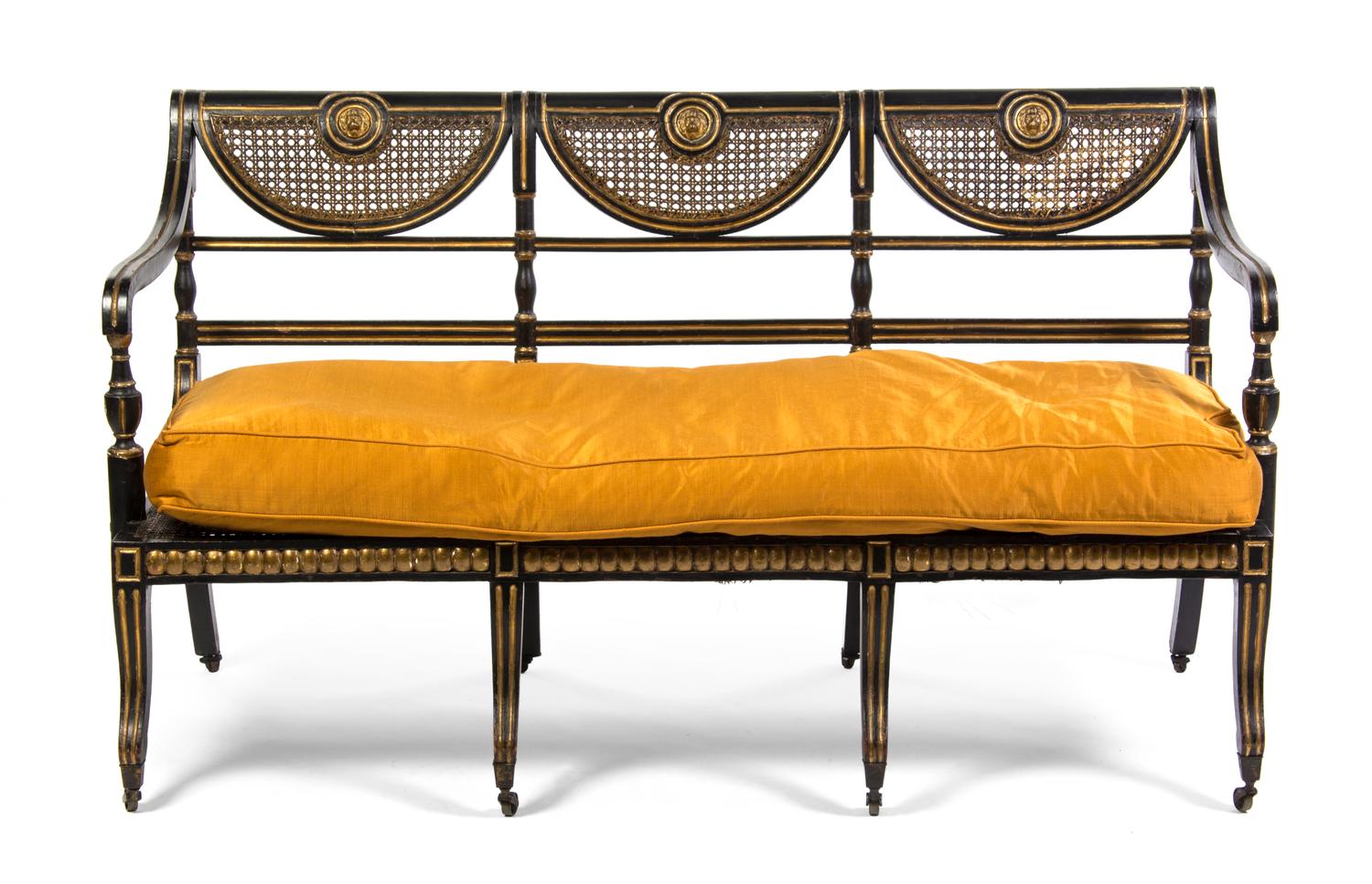 A Regency Ebonized and Parcel Gilt Triple-Back Settee, Width 61 1/4 inches.