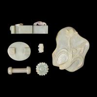 A Group of Five Chinese Pale Celadon and Celadon Jade Items, and a Hardstone "Lotus" Washer 青白玉把件一组