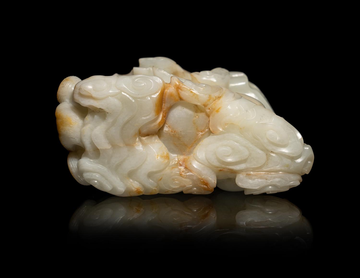 A Chinese Russet and White Jade Carving of a Mythical Beast
