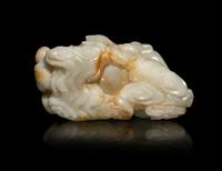 A Chinese Russet and White Jade Carving of a Mythical Beast