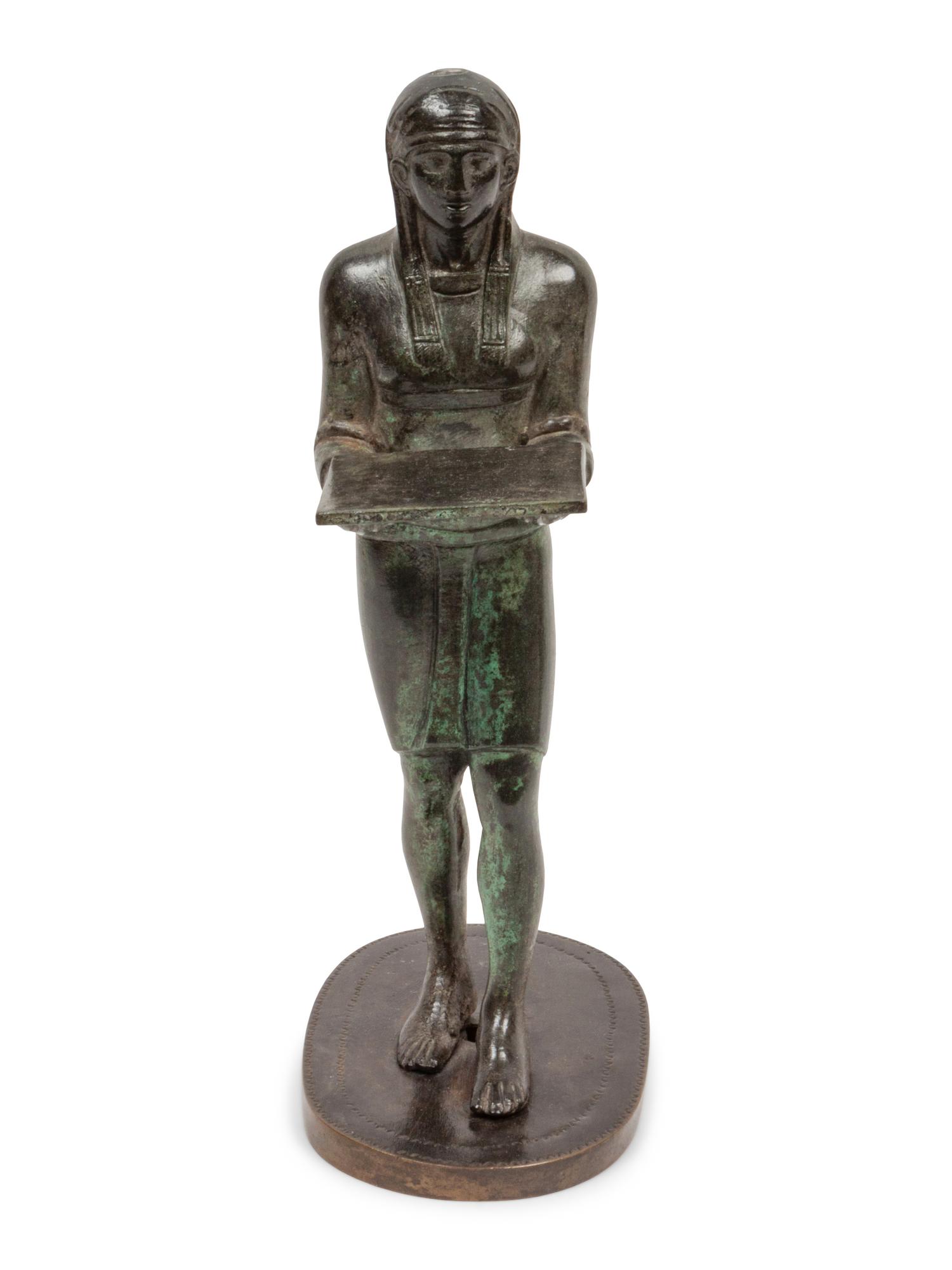 A Patinated Bronze Figure of an Egyptian as an Offering-Bearer