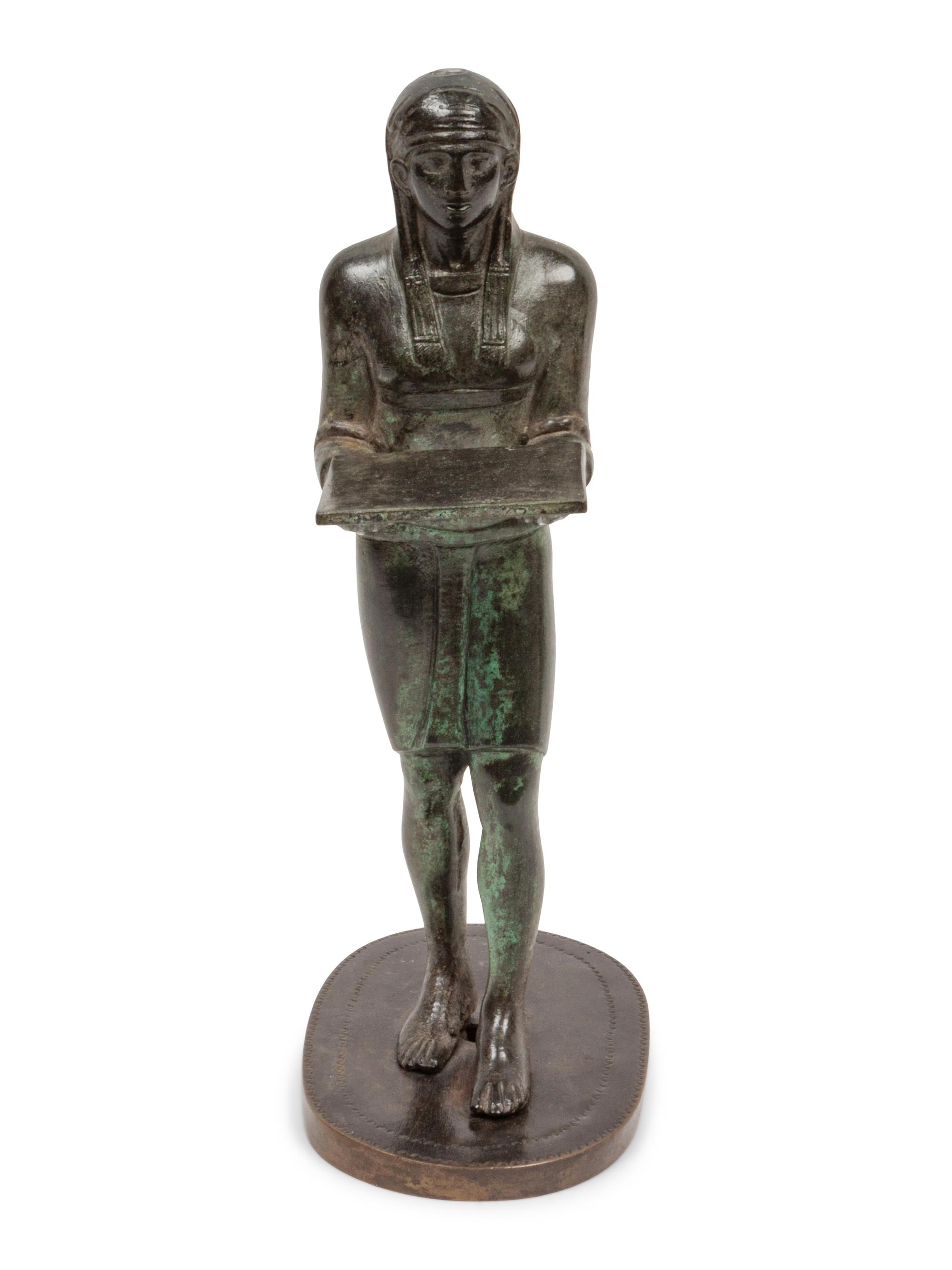 A Patinated Bronze Figure of an Egyptian as an Offering-Bearer