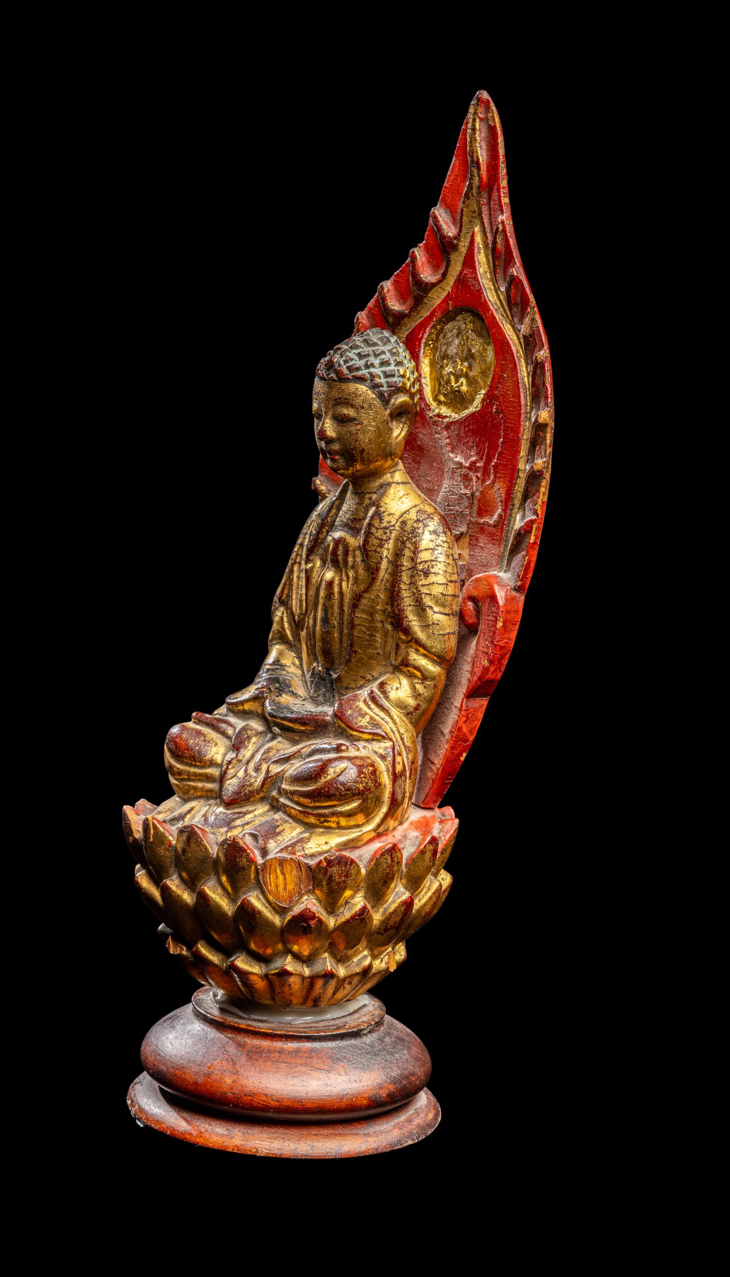 A Gilt and Red Lacquered Wood Figure of Buddha