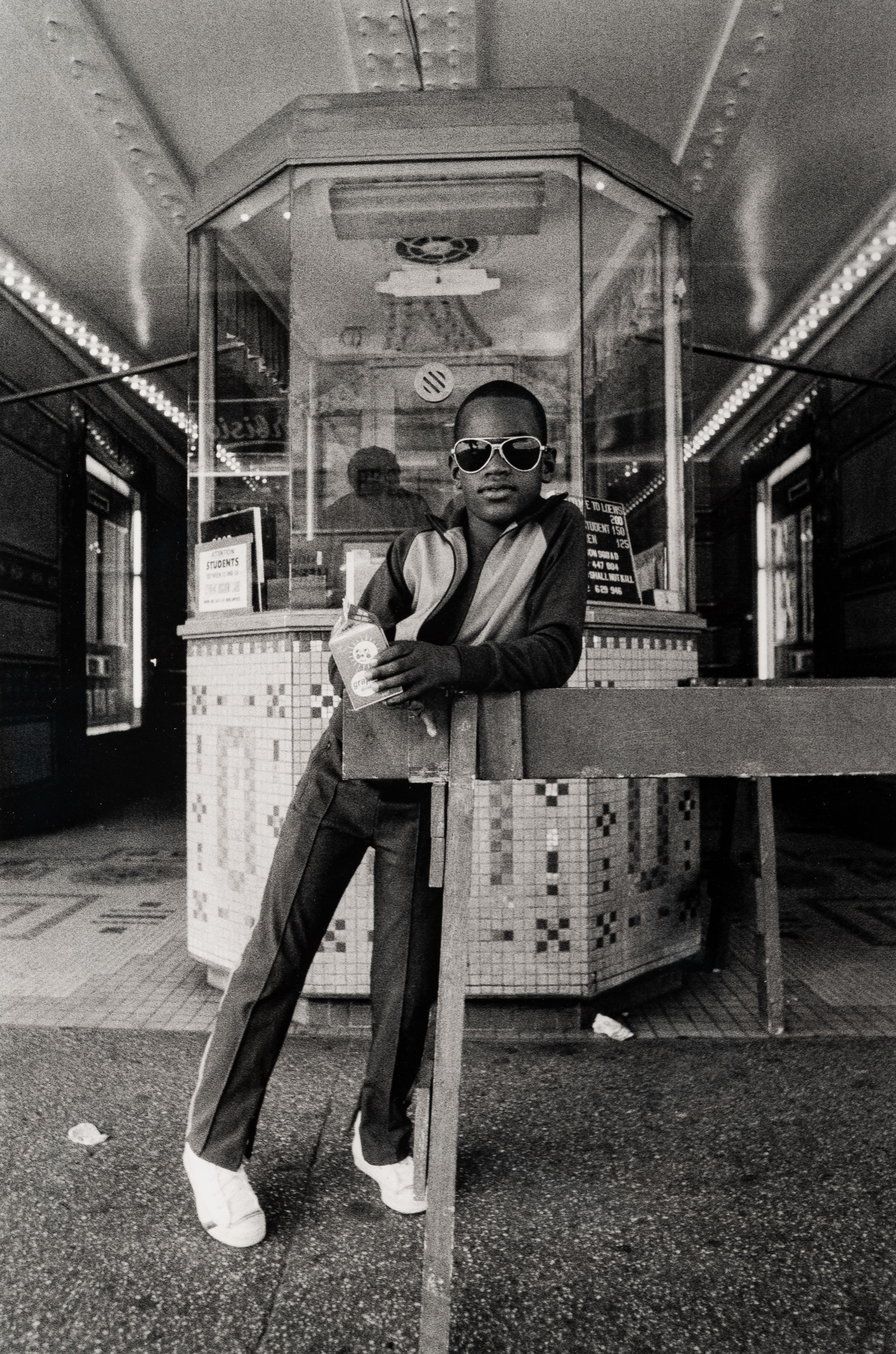Dawoud Bey (American, b. 1953) — A Boy in Front of the Lowe's 125th Street Movie Theatre, 1976, (printed 2012)