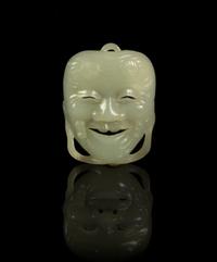 A Jade Miniature Okina Mask Height 1 7/8 inches.