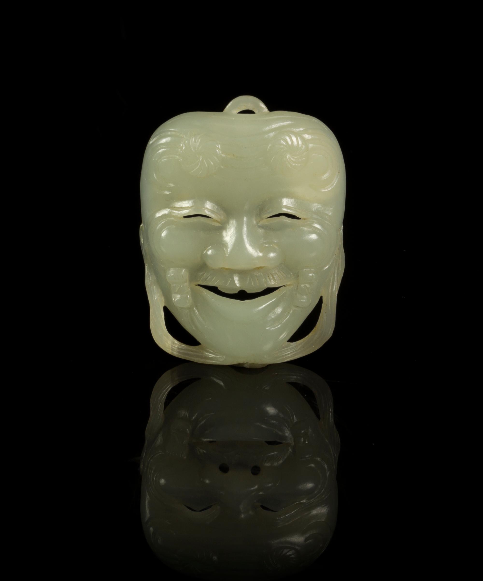 A Jade Miniature Okina Mask Height 1 7/8 inches.