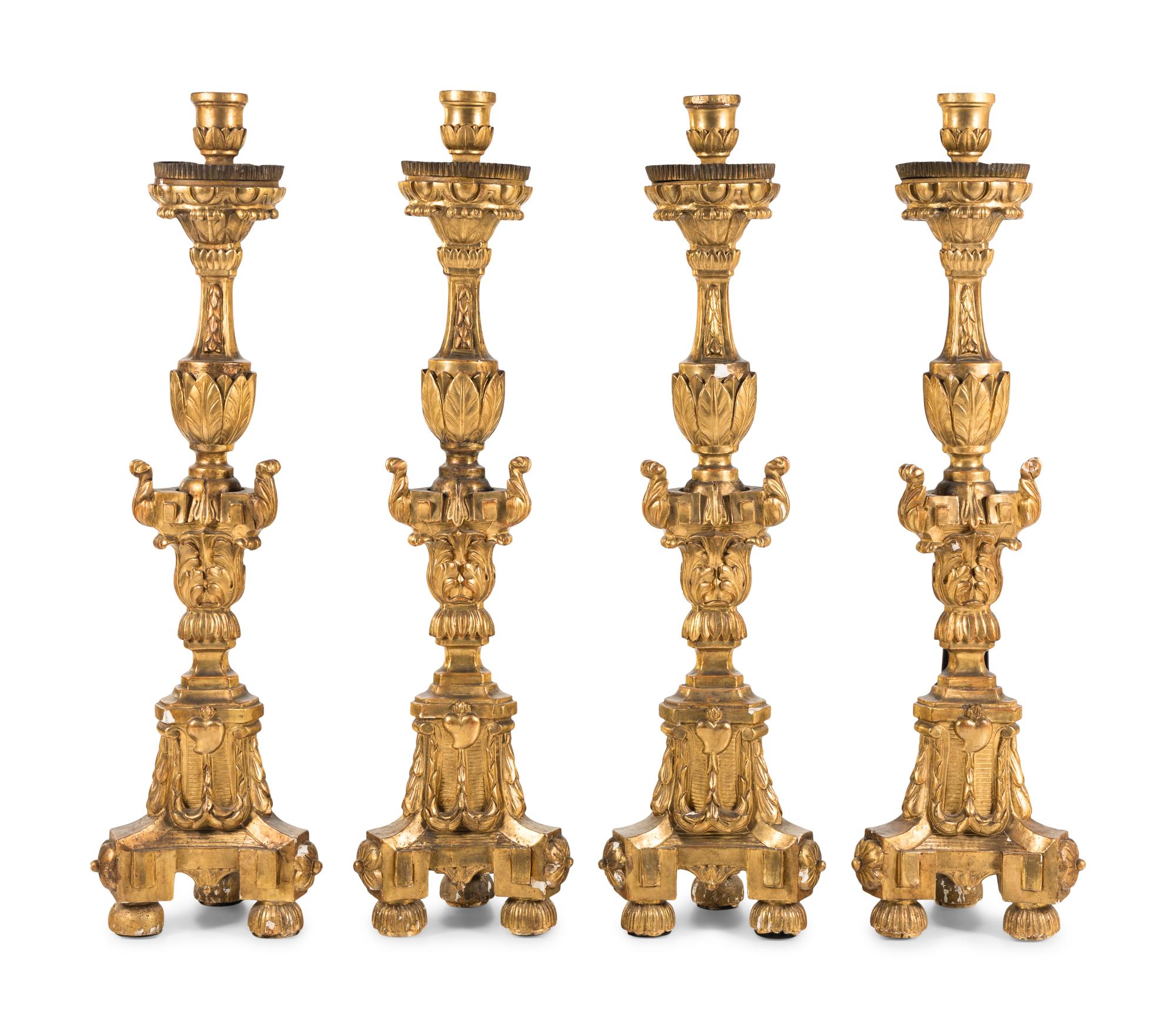 A Set of Four Continental Baroque Style Carved Giltwood Torchères
