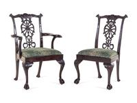 A Set of Eight George III Carved Mahogany Ribbon-Back Dining Chairs