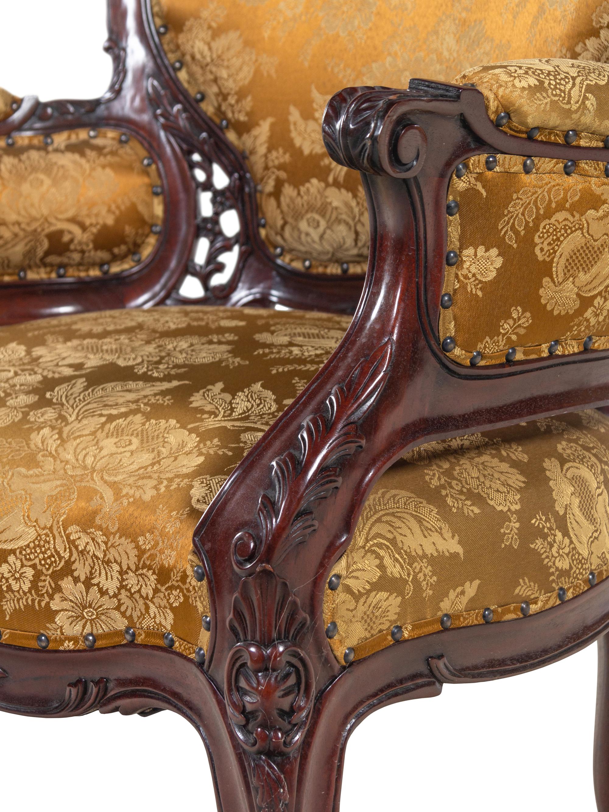A Set of Four Rococo Style Upholstered Mahogany Armchairs