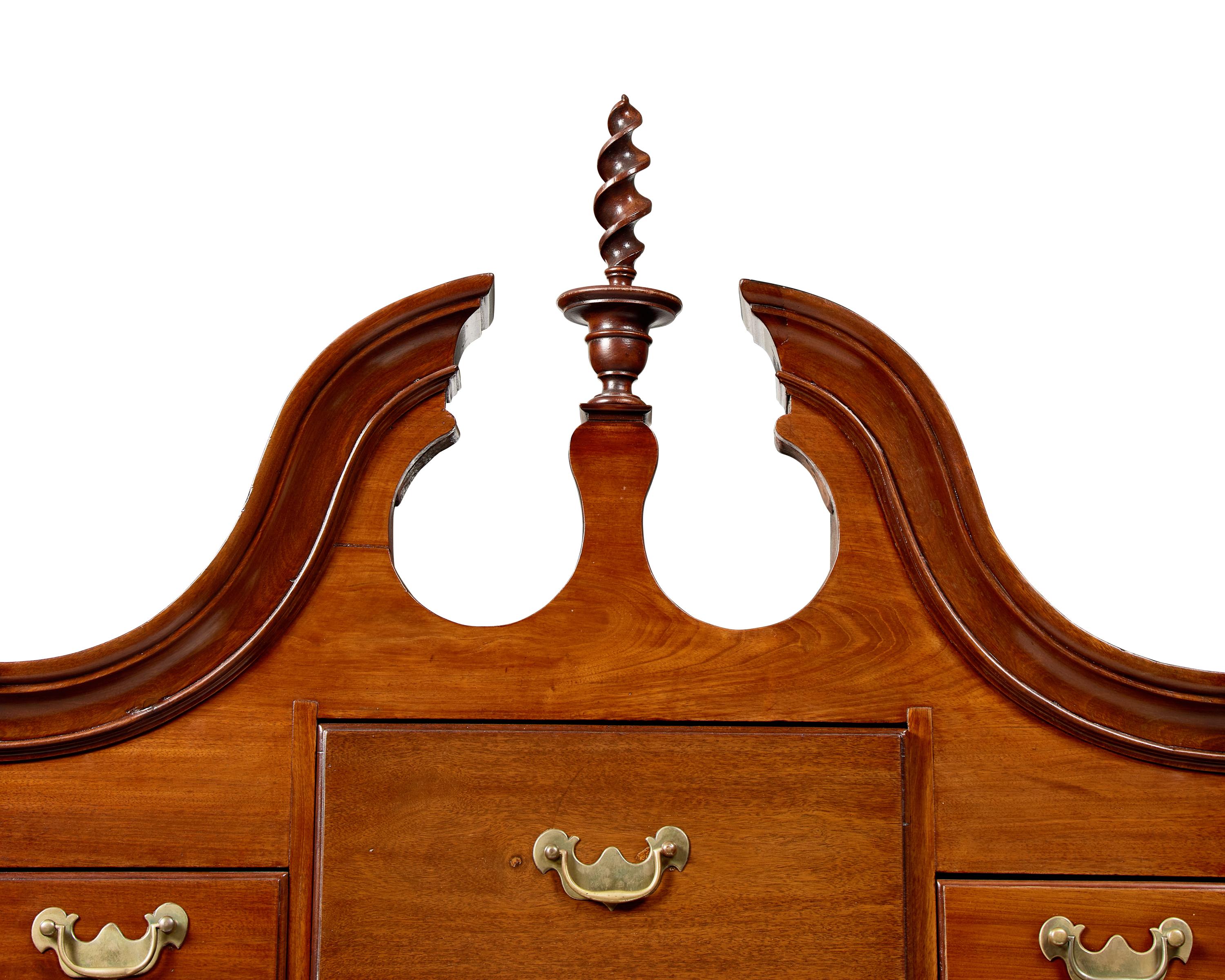 A Queen Anne Carved Walnut Bonnet-Top High Chest of Drawers