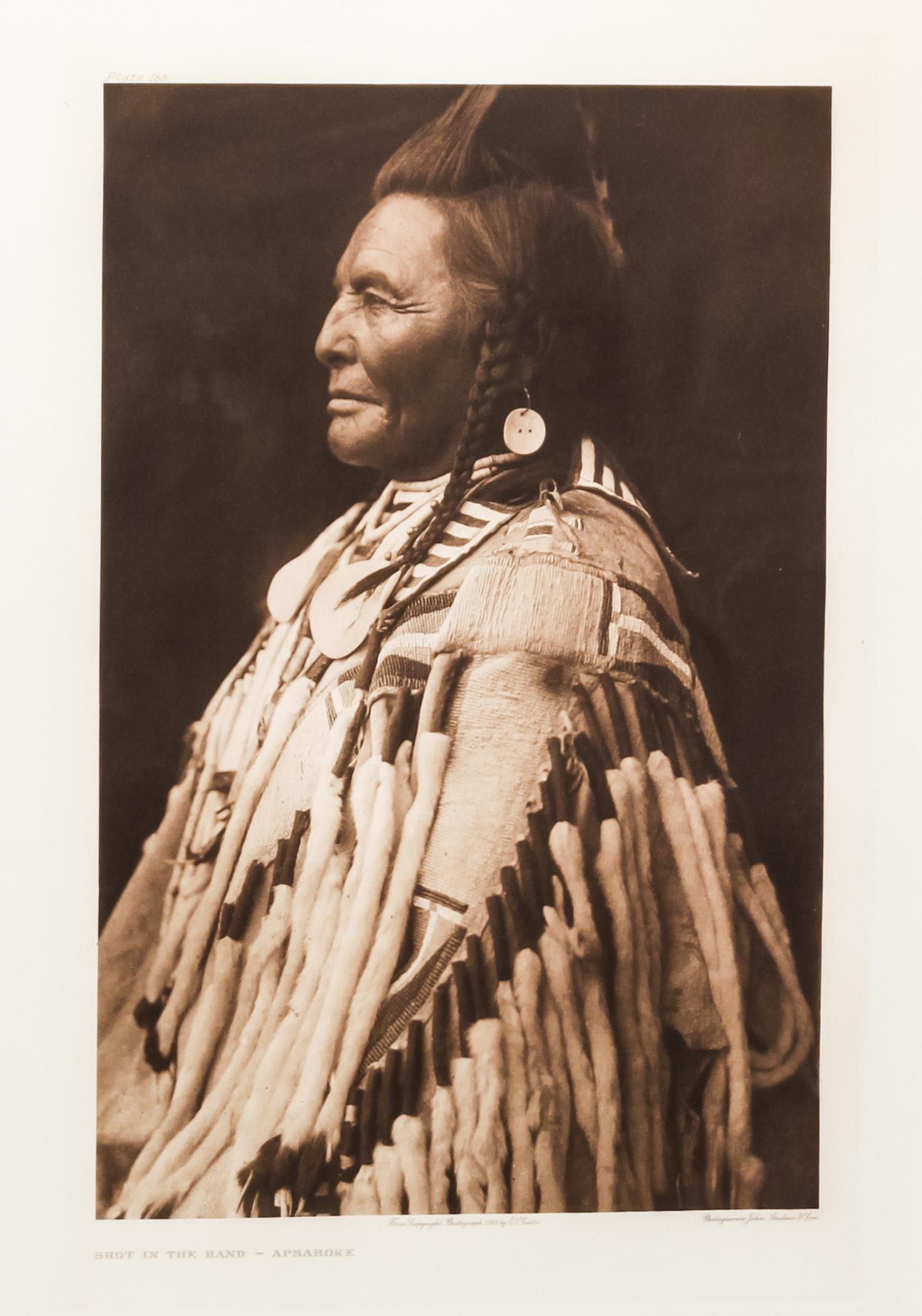 Edward Sheriff Curtis, (American, 1868-1952), three photogravuresShot in the Hand-Apsaroke Plate 133, Arikara Medicine Fraternity Plate