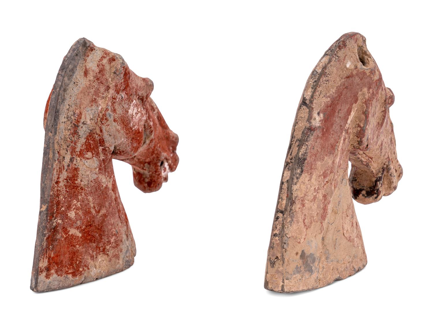 Two Chinese Red Glazed Pottery Horse Heads