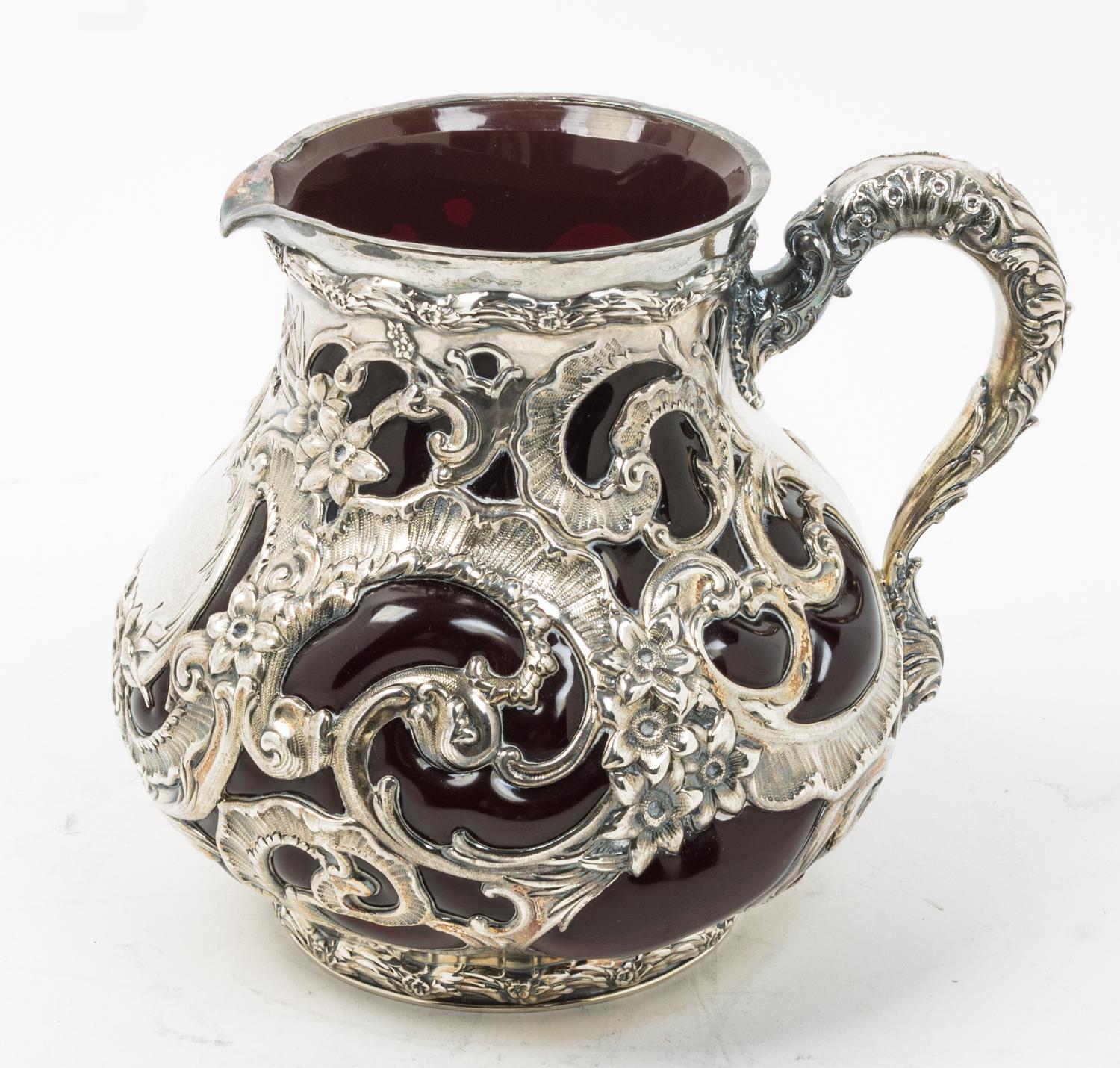 An American Silver Mounted Glass Water Pitcher, Whiting Mfg. Co., New York, NY, the silver liner worked with openwork floral, foliate a