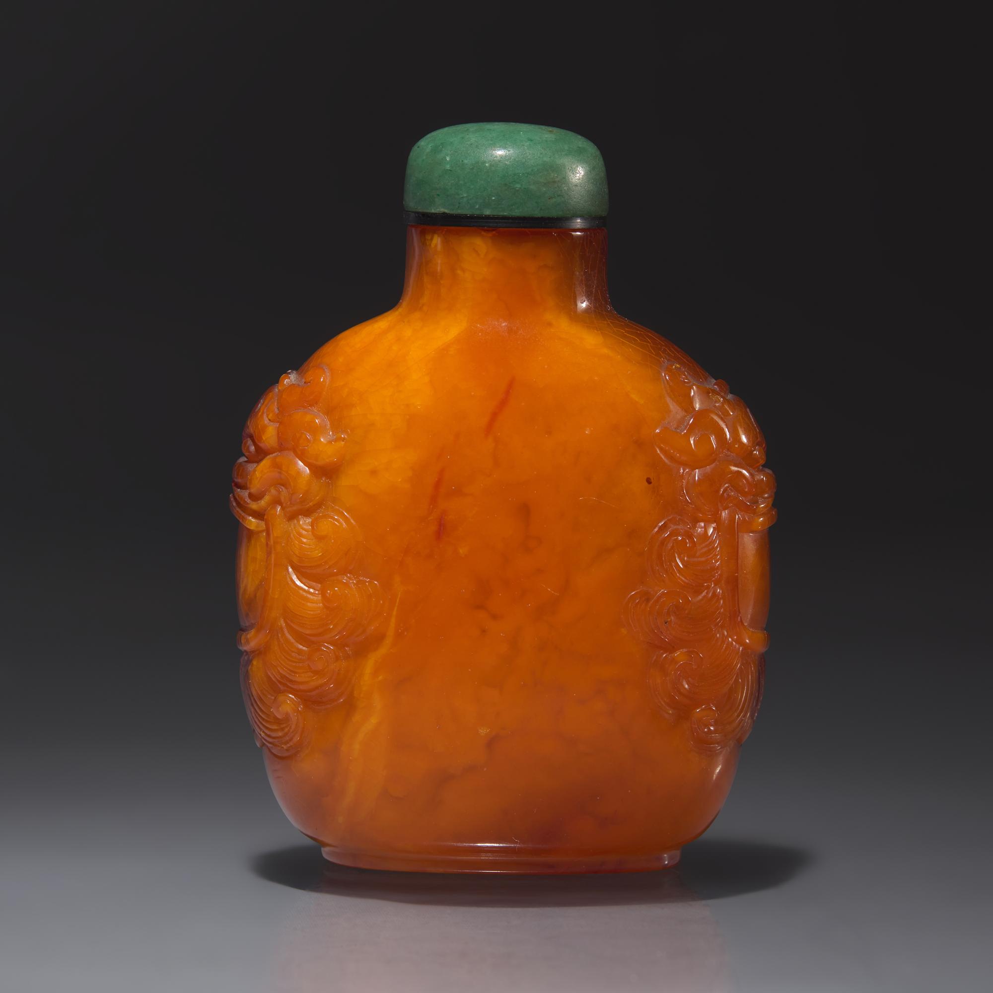A Chinese Carved Amber Snuff Bottle, Qing Dynasty, Late 18th Century — 清中期 琥珀鋪首啣環耳鼻煙壺