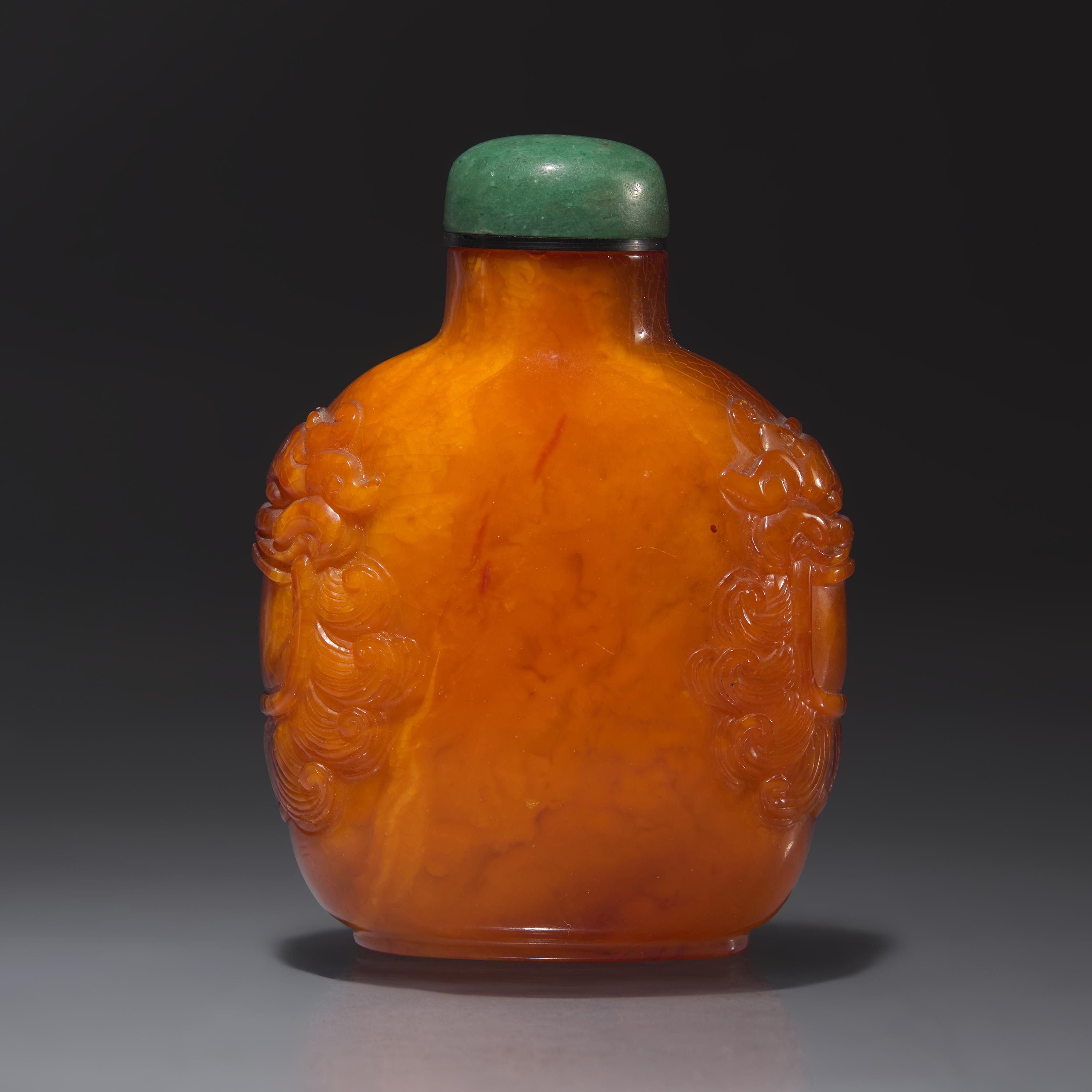 A Chinese Carved Amber Snuff Bottle, Qing Dynasty, Late 18th Century — 清中期 琥珀鋪首啣環耳鼻煙壺
