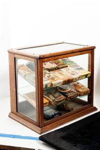 A Collection of Fifteen Tobacco Cartons and a Tobacco Rope in Display Case