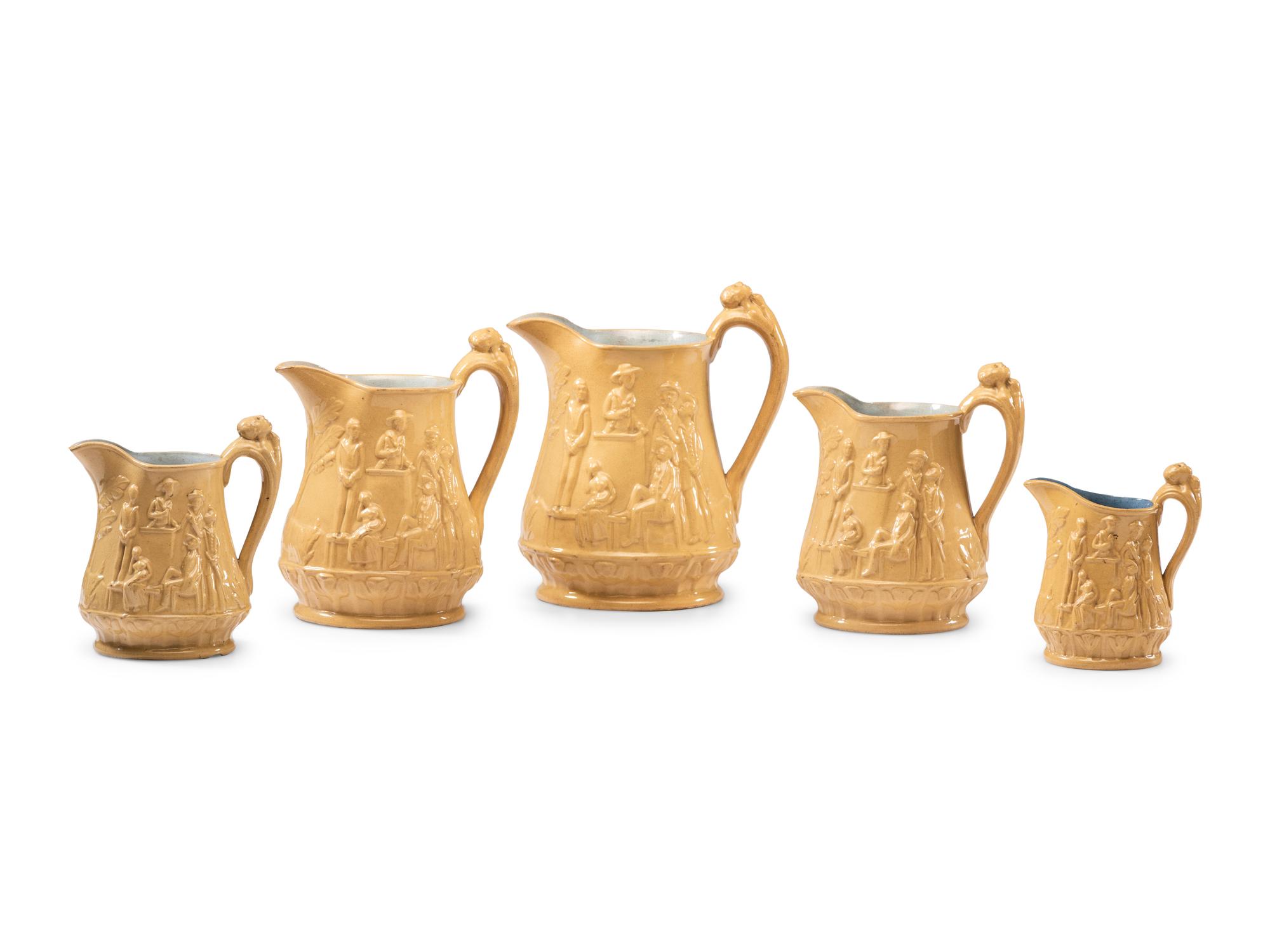 Five Graduated Abolitionist Yellowware Pitchers with Molded Scenes from Uncle Tom's Cabin