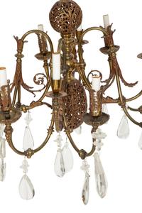A Pierced Brass Eight-Light Chandelier with Crystal Drops