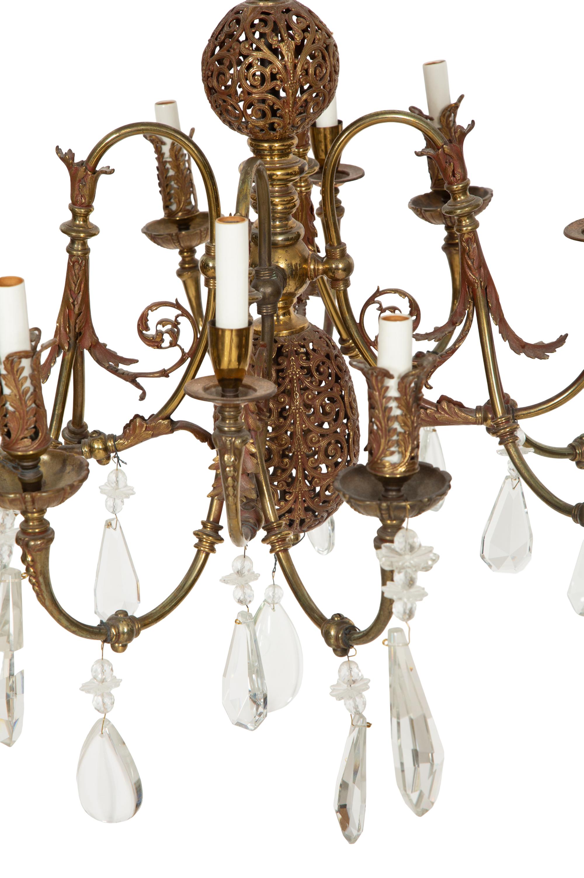 A Pierced Brass Eight-Light Chandelier with Crystal Drops