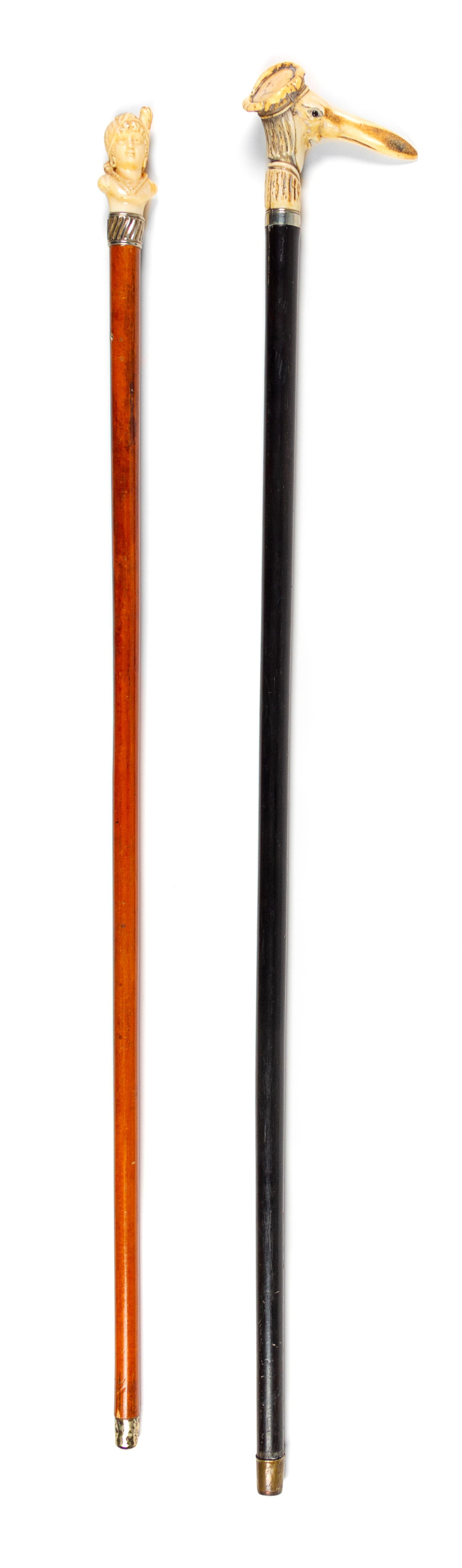 Two Continental Carved Figural Walking Sticks Length of longer 36 inches. — LATE 19TH CENTURY