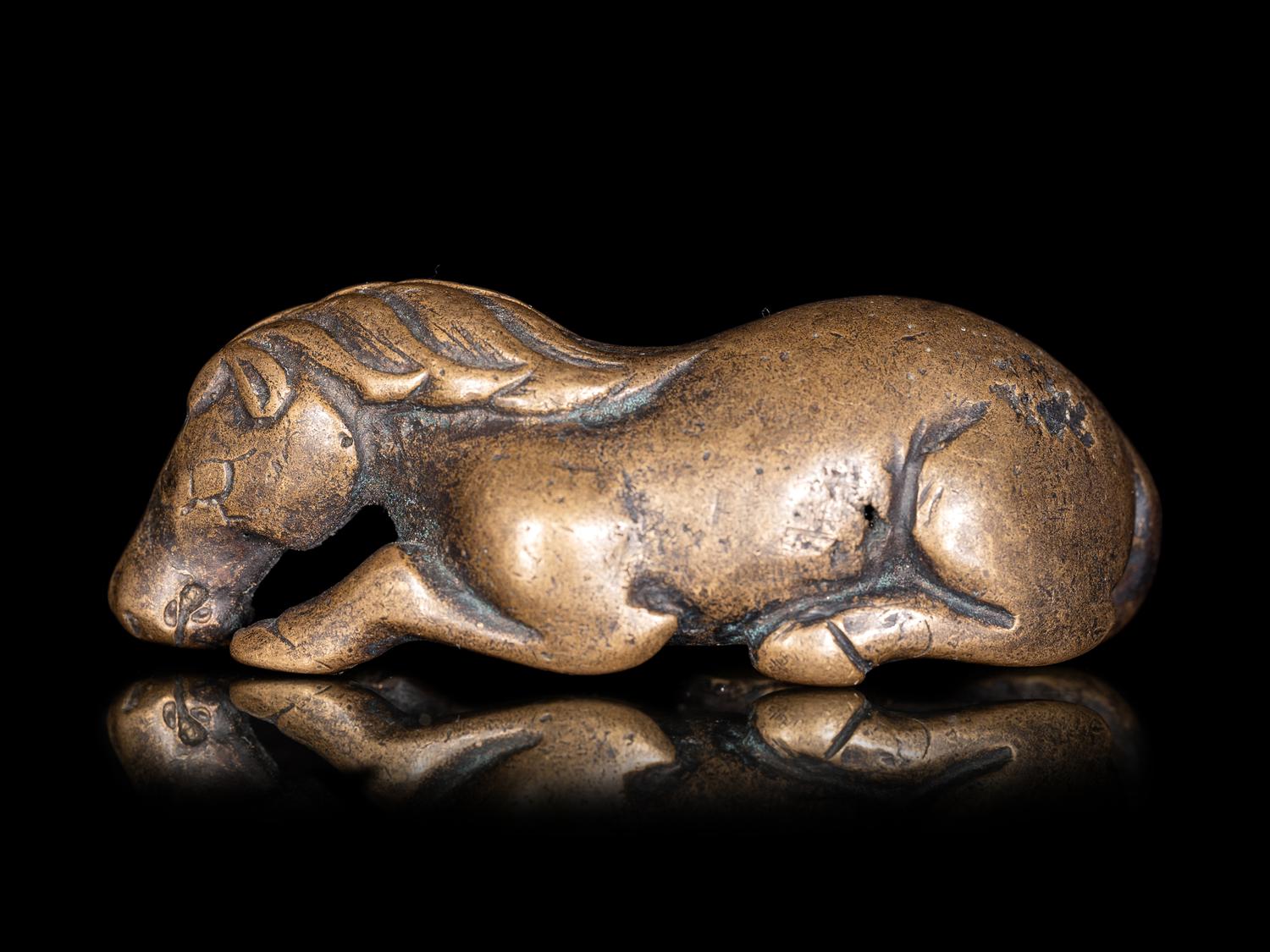 A Chinese Gilt Bronze Figure of a Recumbent Horse