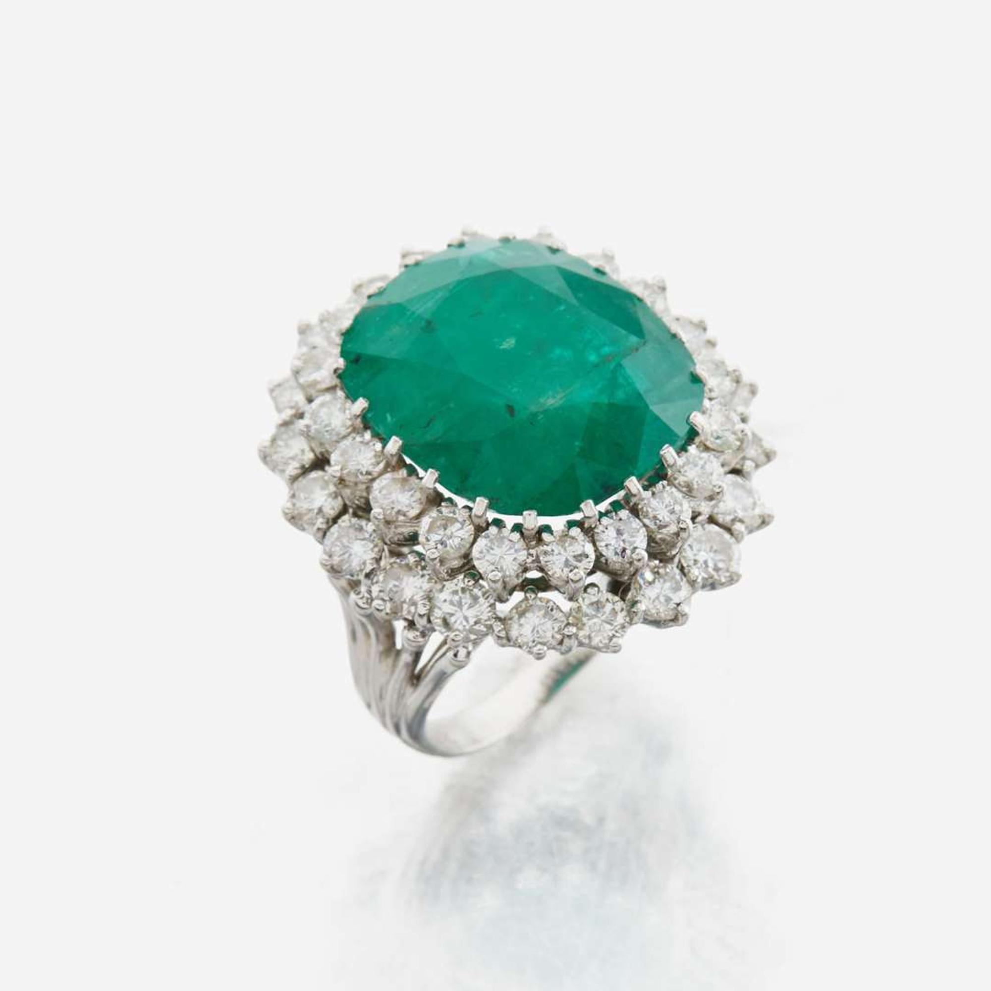 An emerald, diamond and white gold ring