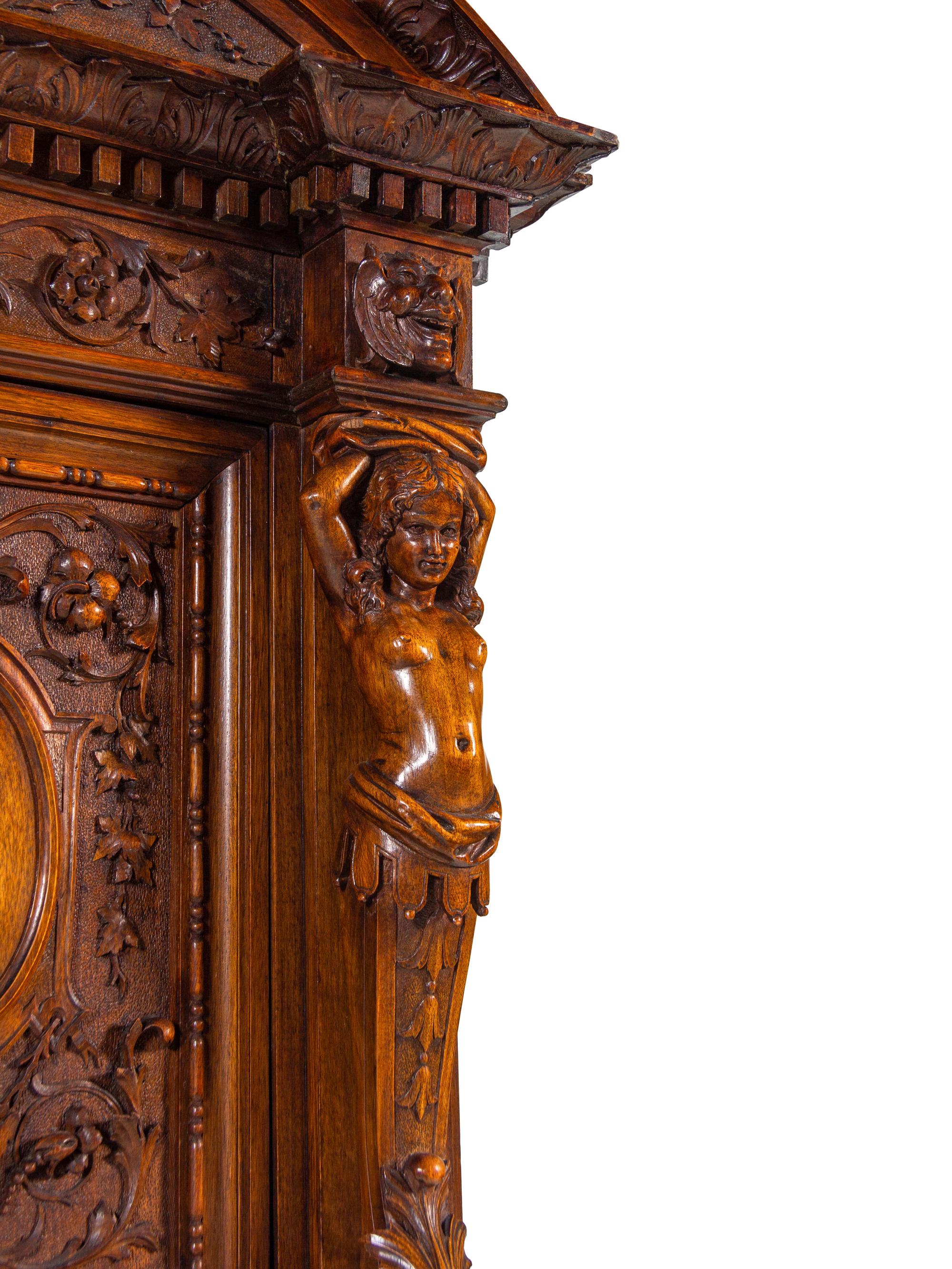 A Renaissance Revival Carved Walnut Cabinet on Stand