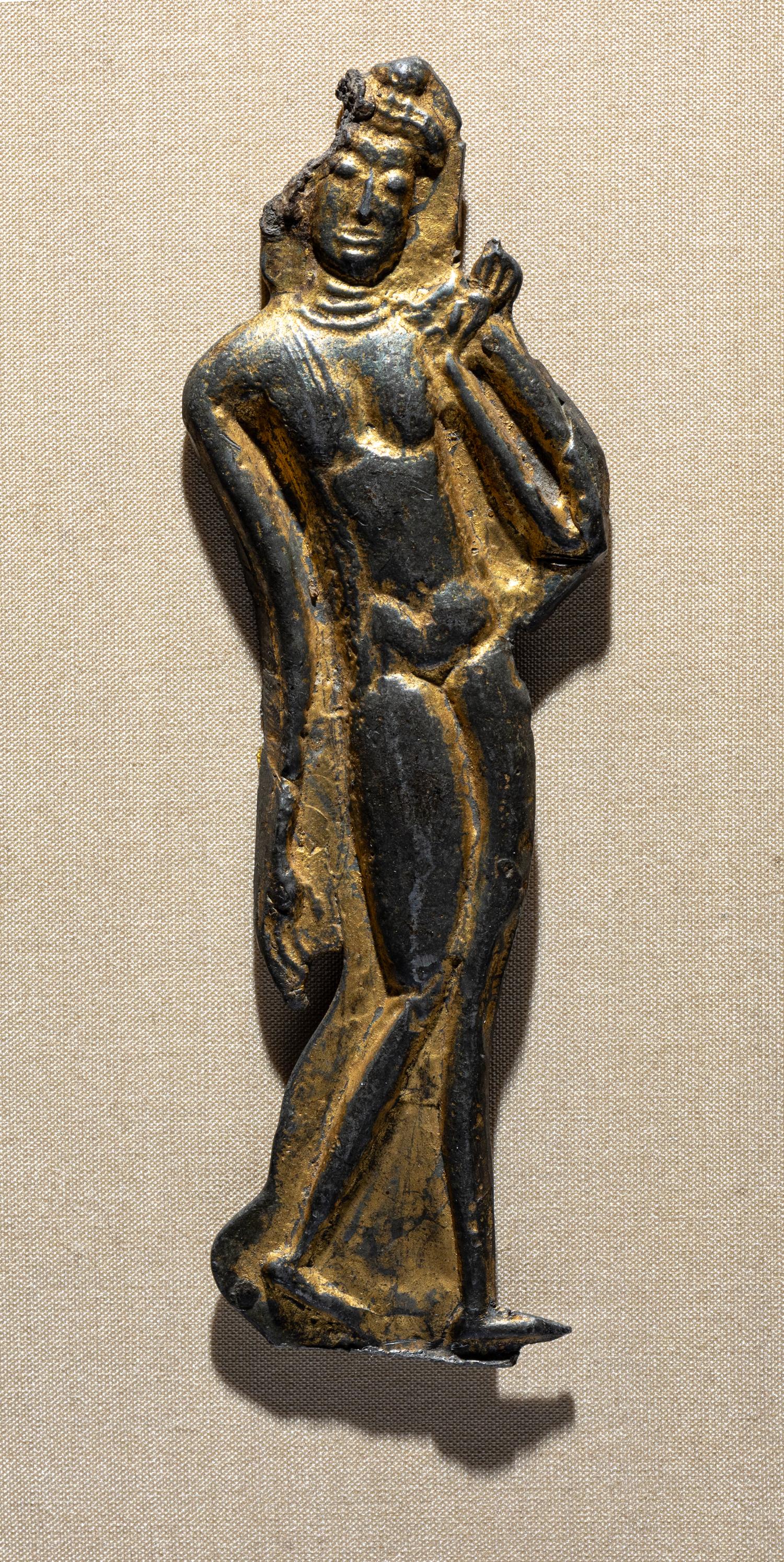 A Thai Parcel Gilt Bronze Relief of a Walking Buddha, 16th-17th Century