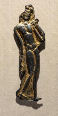 A Thai Parcel Gilt Bronze Relief of a Walking Buddha, 16th-17th Century