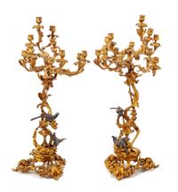 A Pair of Louis XV Style Gilt and Patinated Bronze Twelve-Light Candelabra