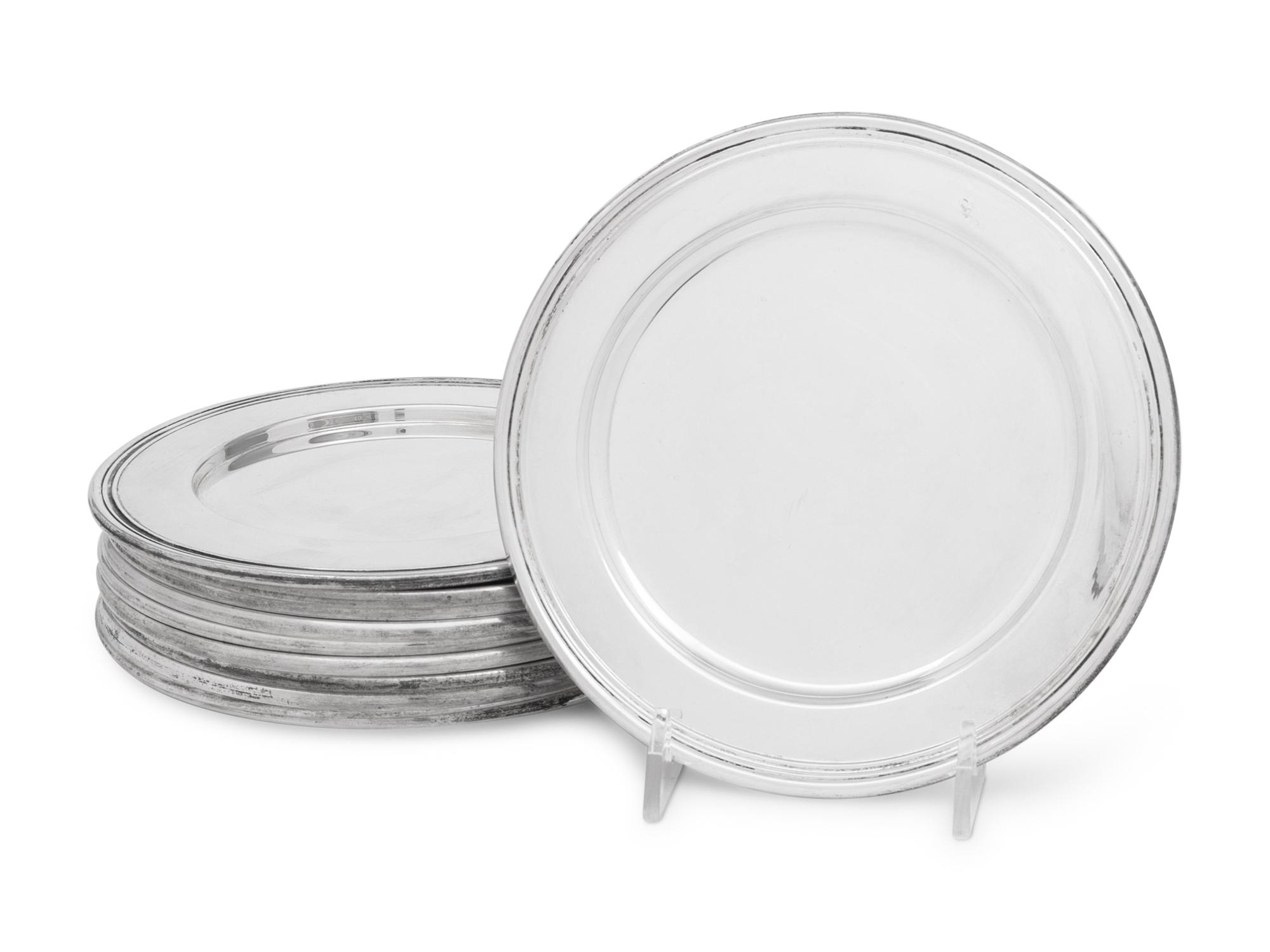 A Set of Eleven Cartier Silver Bread Plates