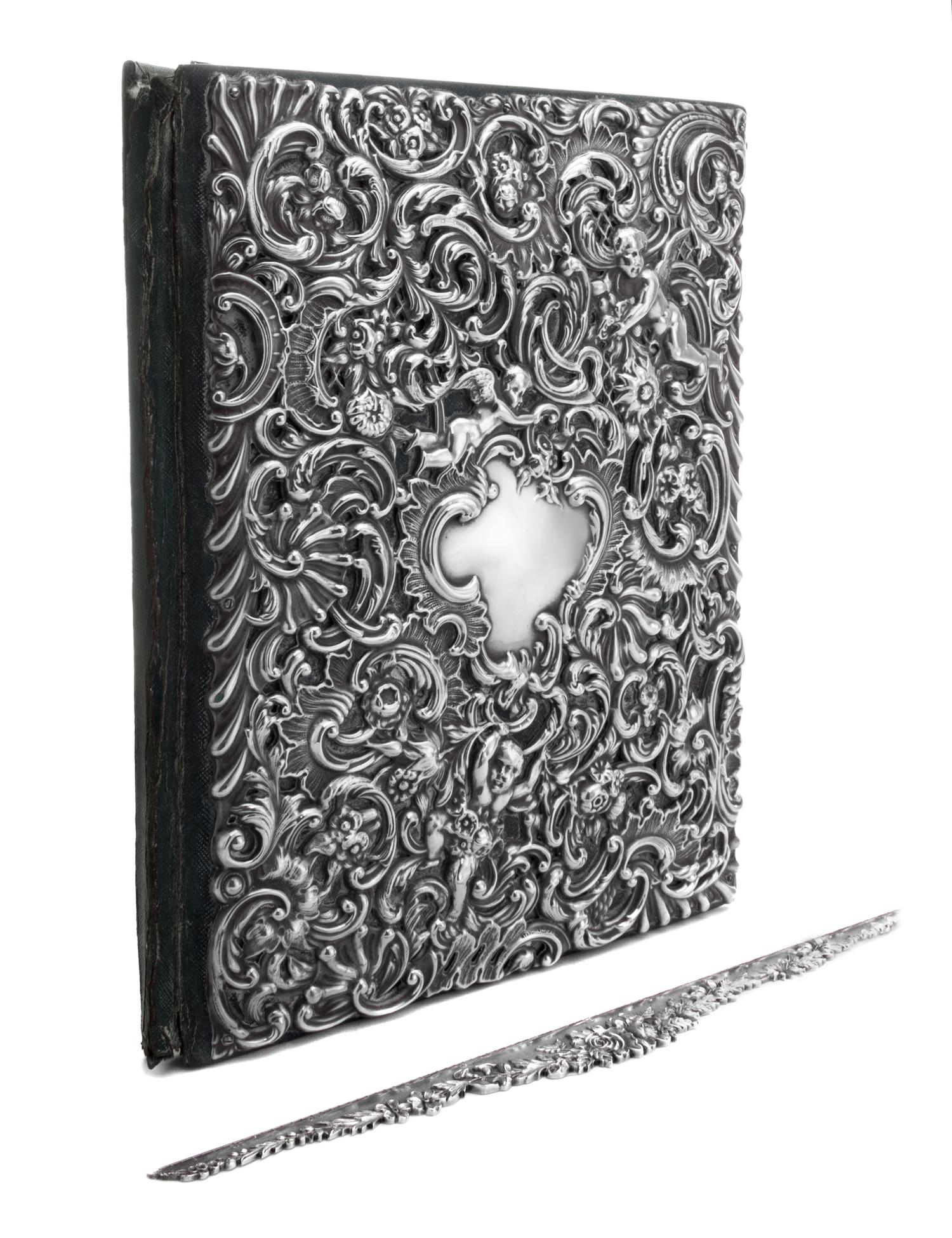 An American Silver Repousse Portfolio, Dominick & Haff, New York, NY, the portfolio cover decorated with rocaille, floral, foliate and