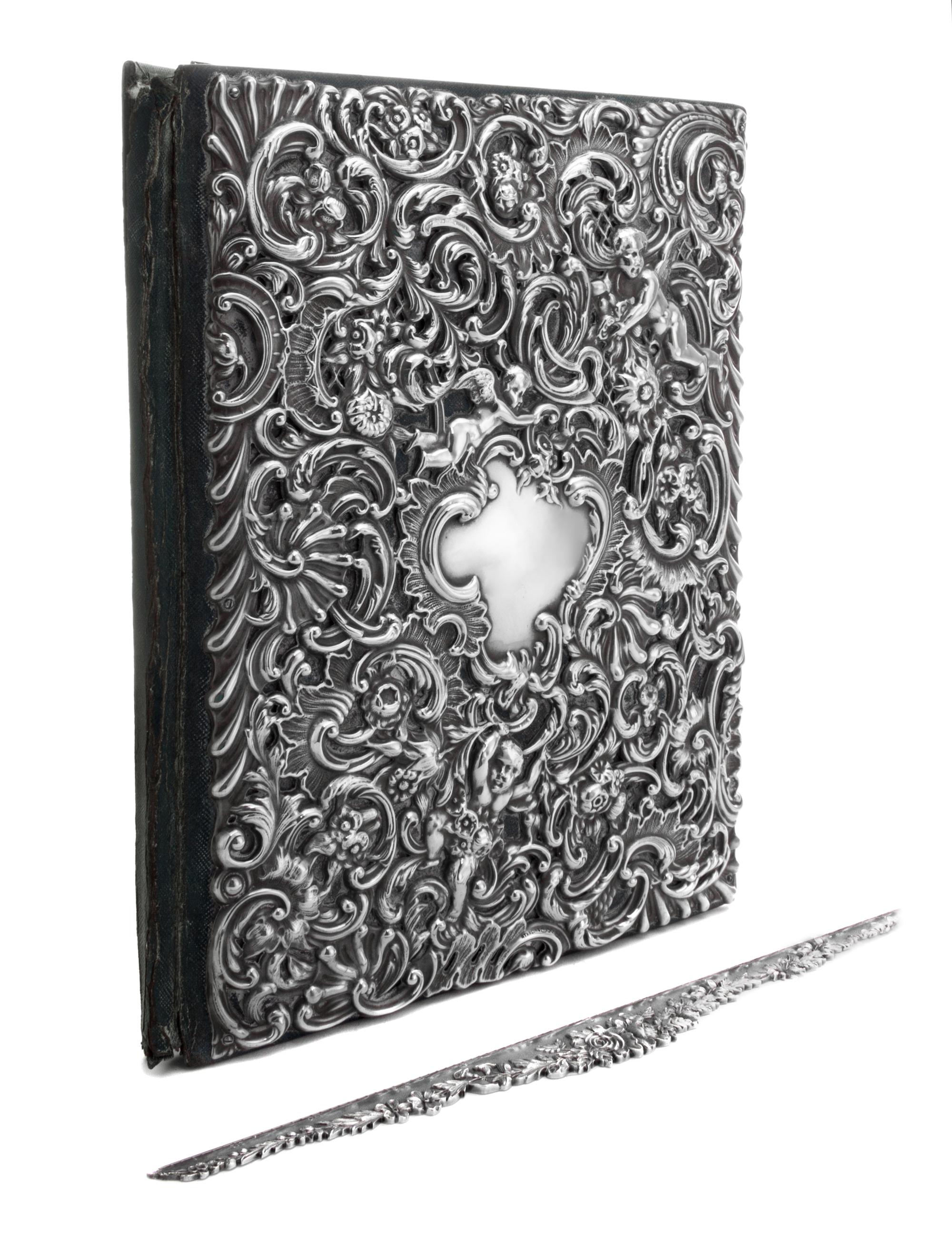 An American Silver Repousse Portfolio, Dominick & Haff, New York, NY, the portfolio cover decorated with rocaille, floral, foliate and