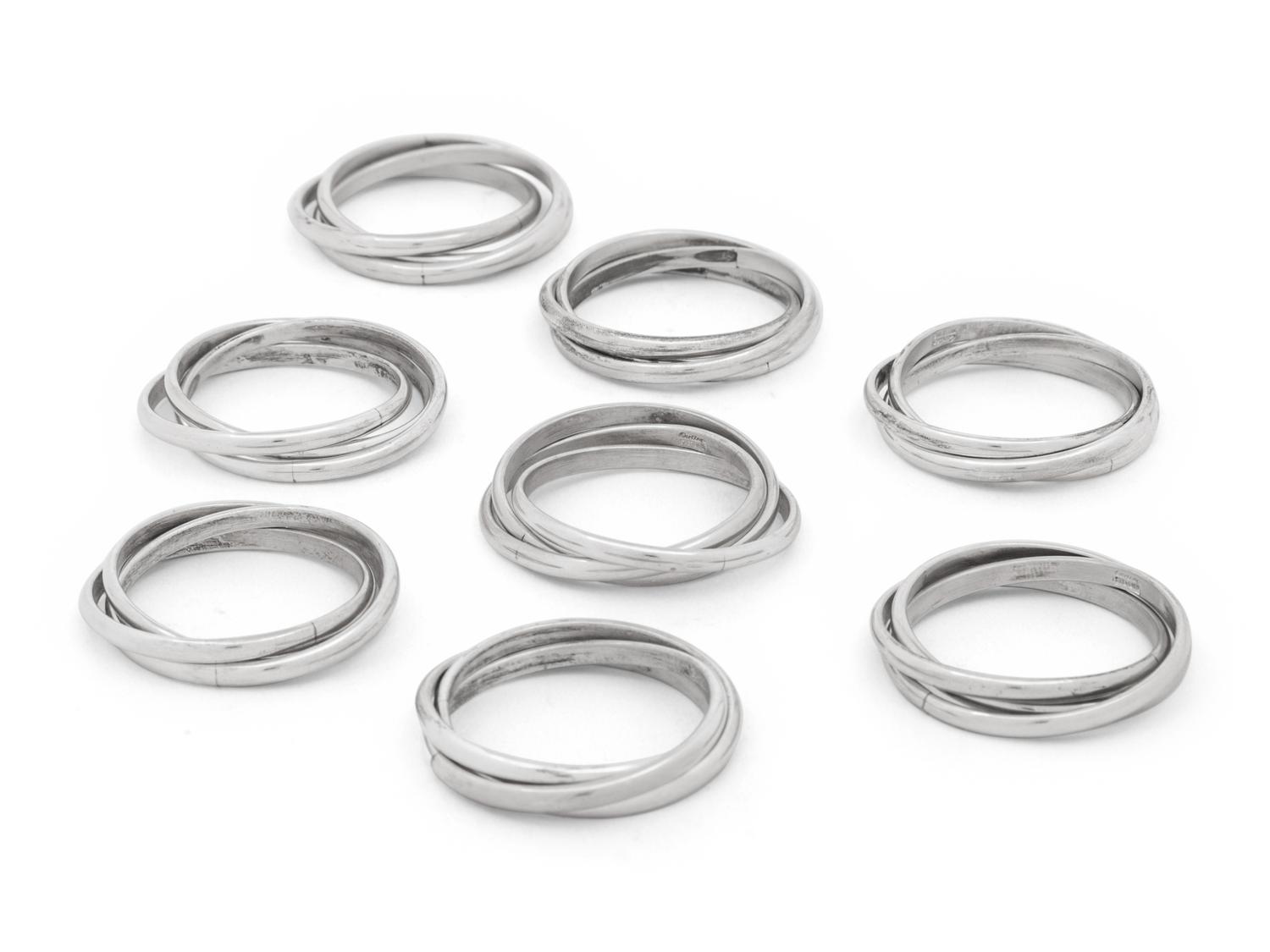 Two Cased Sets of Four Cartier Trinity Silver Napkin Rings
