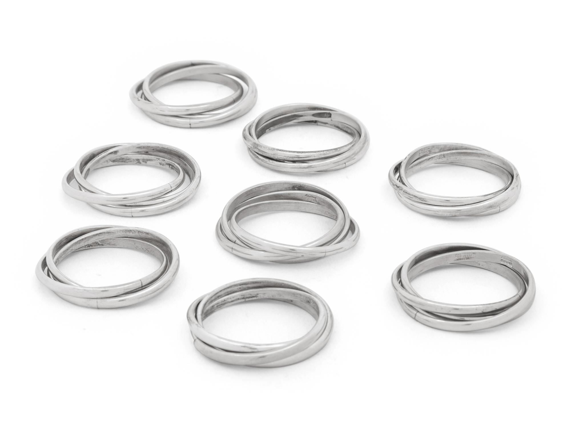 Two Cased Sets of Four Cartier Trinity Silver Napkin Rings