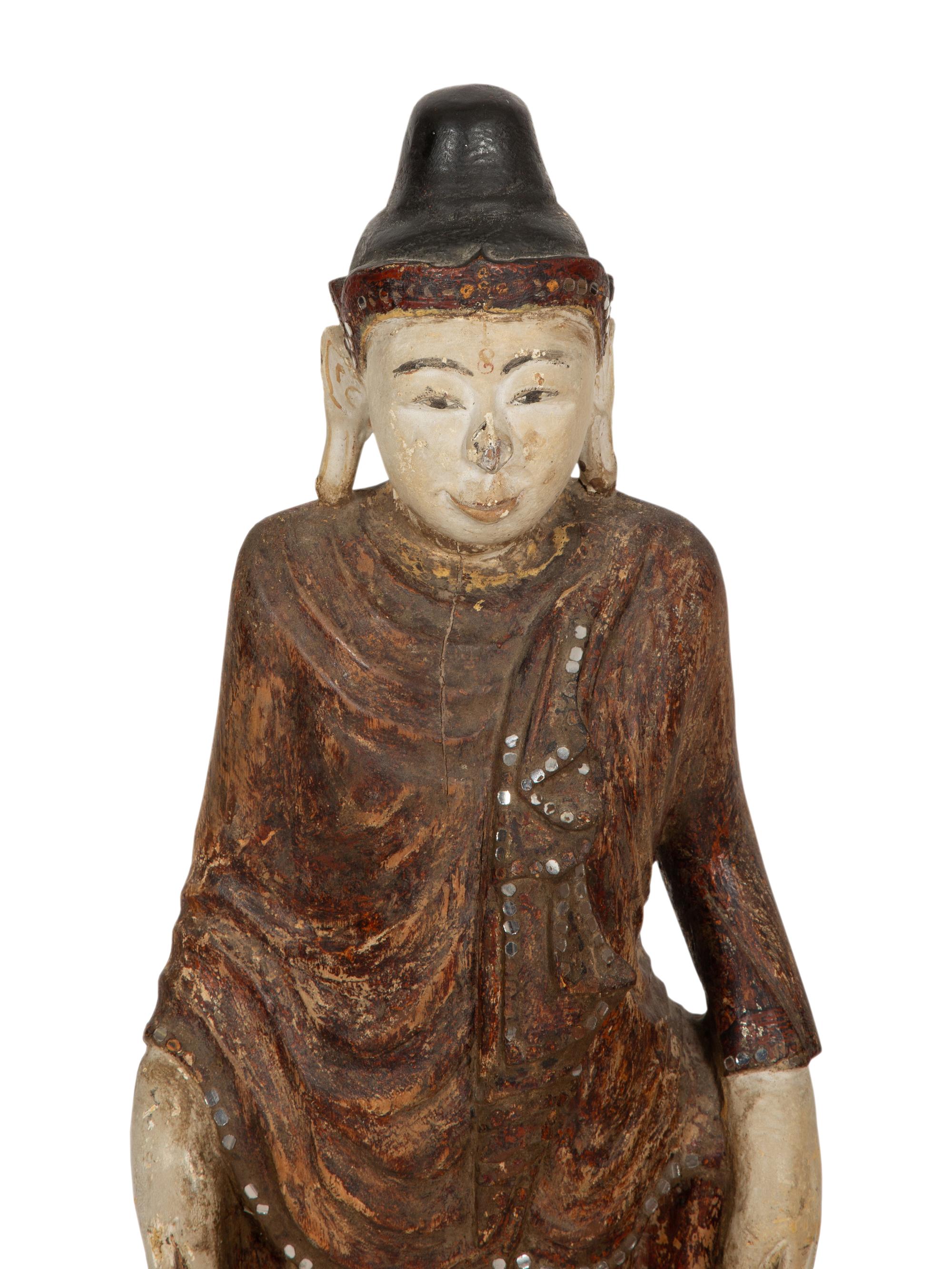 An Indonesian Carved and Painted Figure of a Buddhist Monk