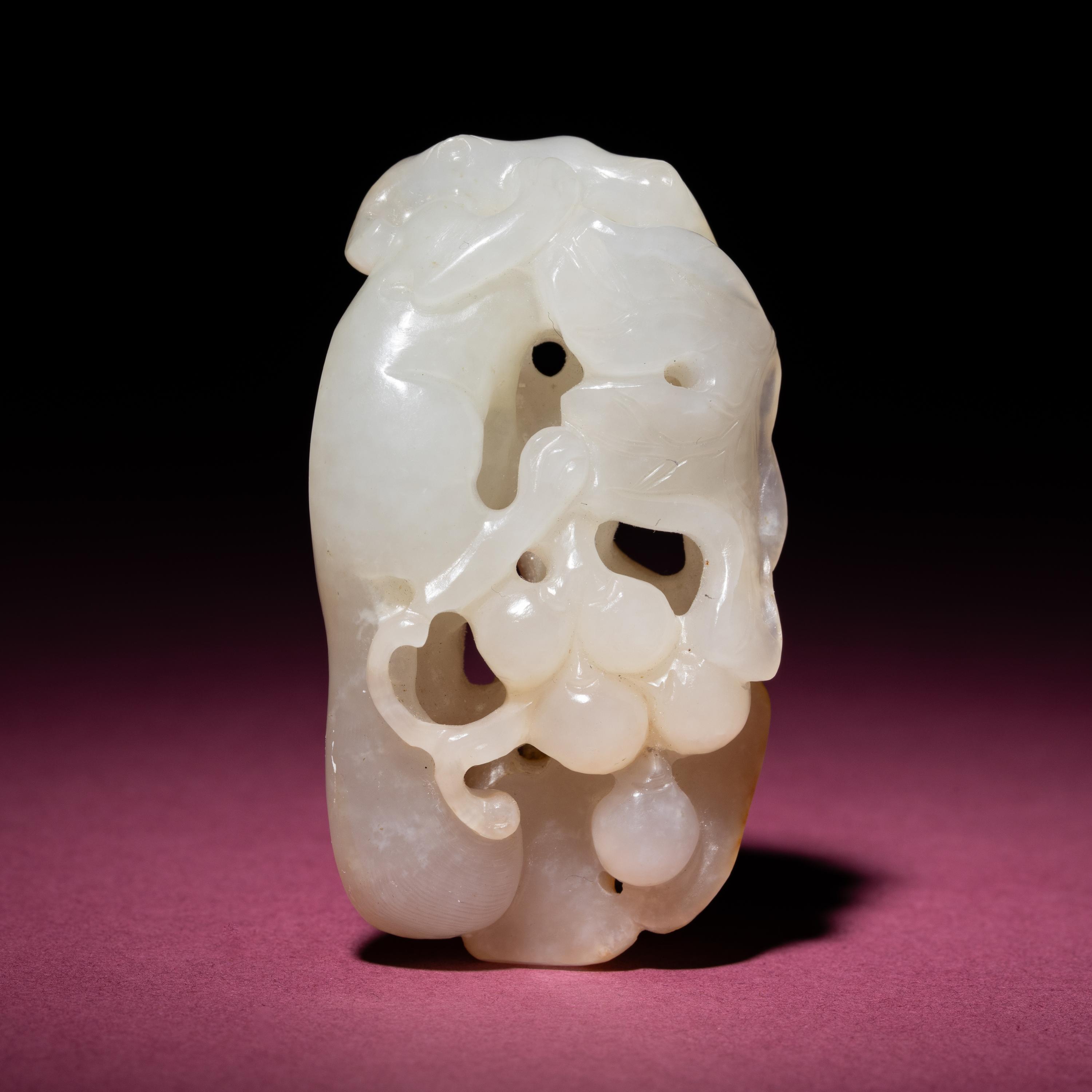 A Chinese Russet and White Jade 'Squirrel and Grape' Carving, 18th/19th Century — 清中期 白玉留皮松鼠葡萄