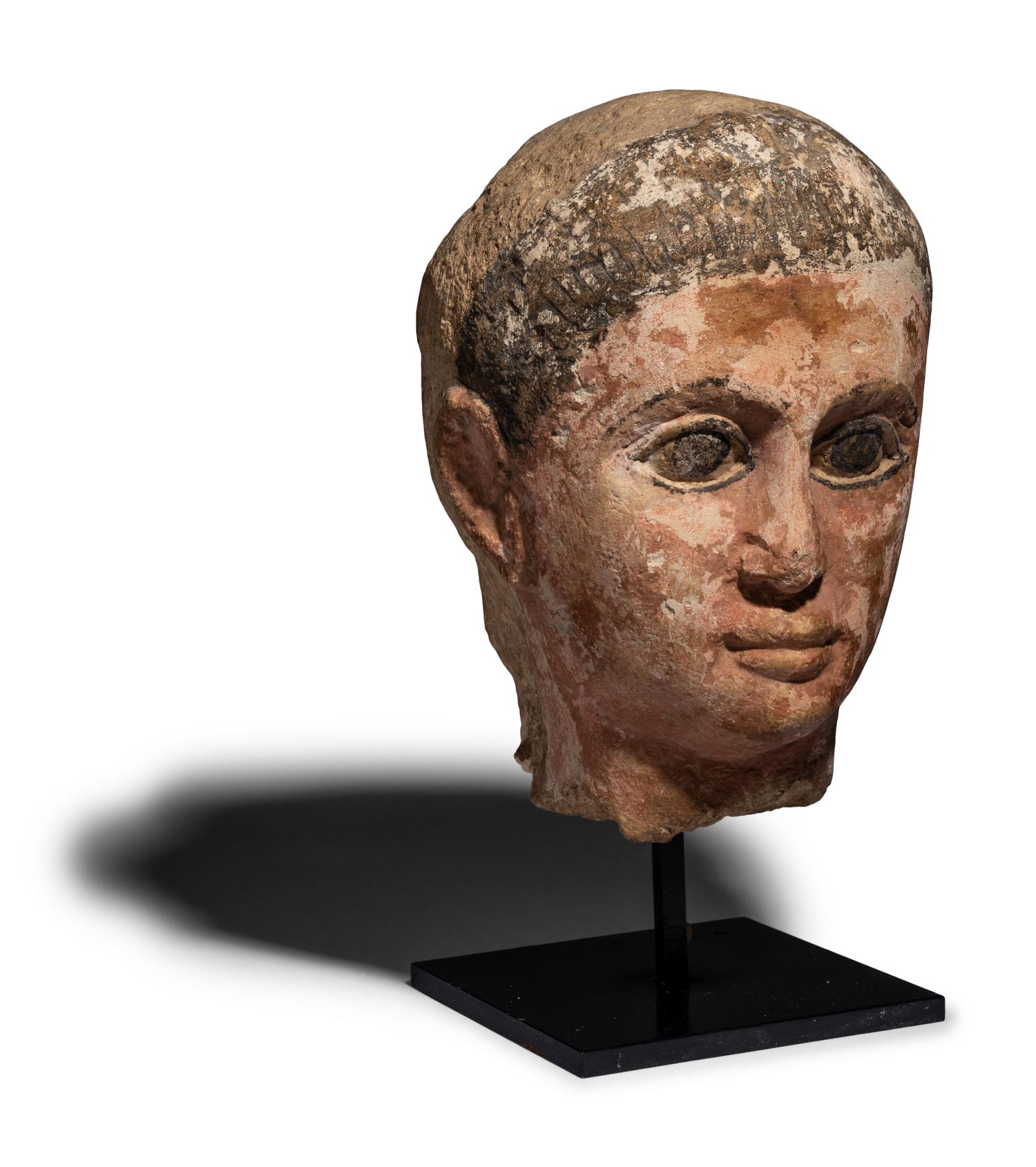 An Egyptian Painted Limestone Head of a Youth