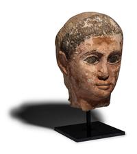 An Egyptian Painted Limestone Head of a Youth