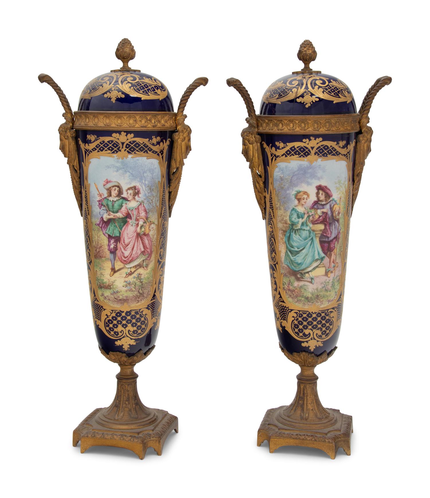 A Pair of Sèvres Style Gilt Bronze Mounted Porcelain Urns