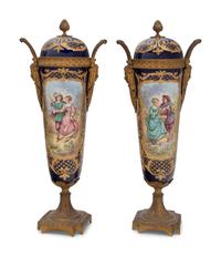 A Pair of Sèvres Style Gilt Bronze Mounted Porcelain Urns