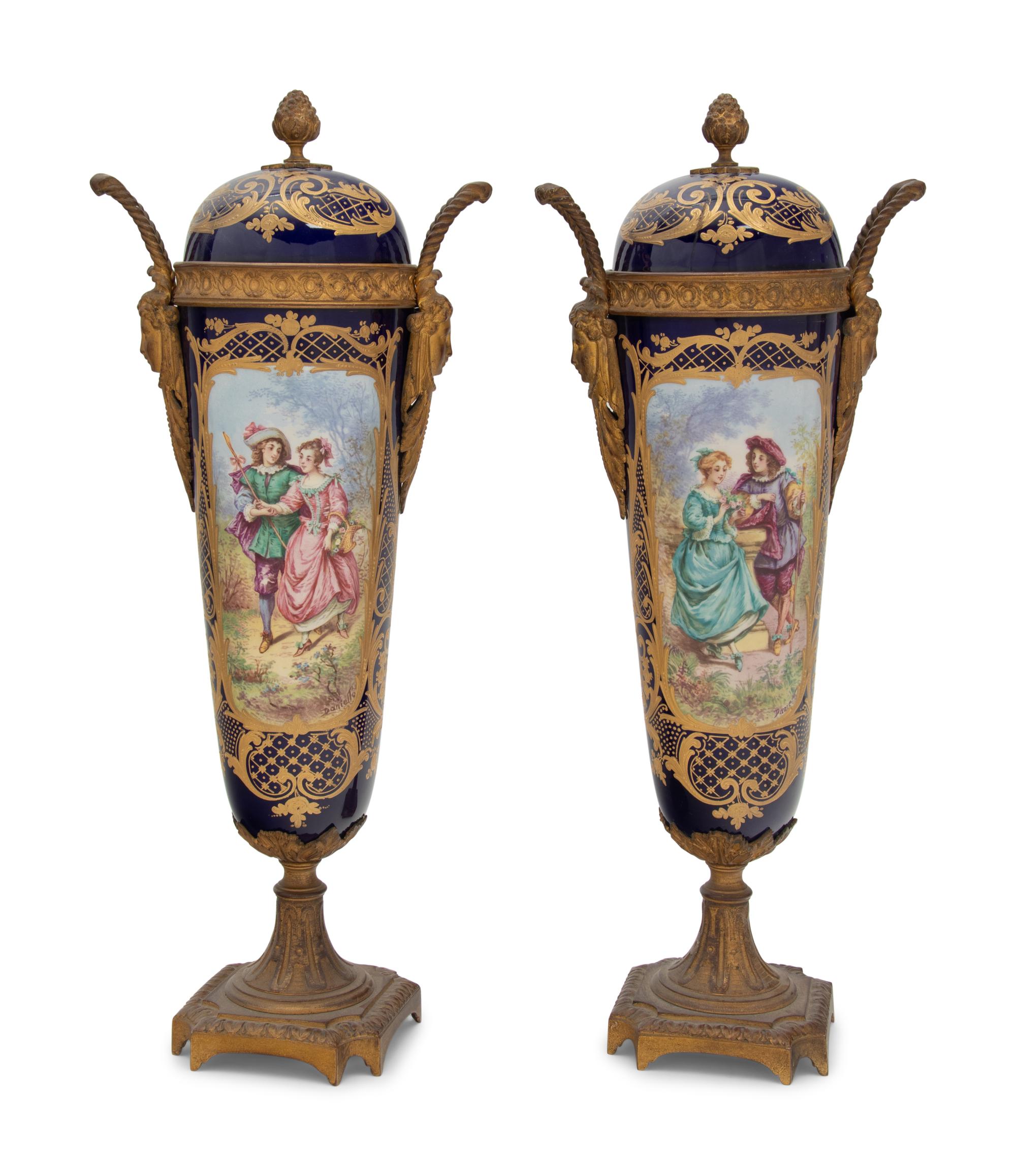 A Pair of Sèvres Style Gilt Bronze Mounted Porcelain Urns