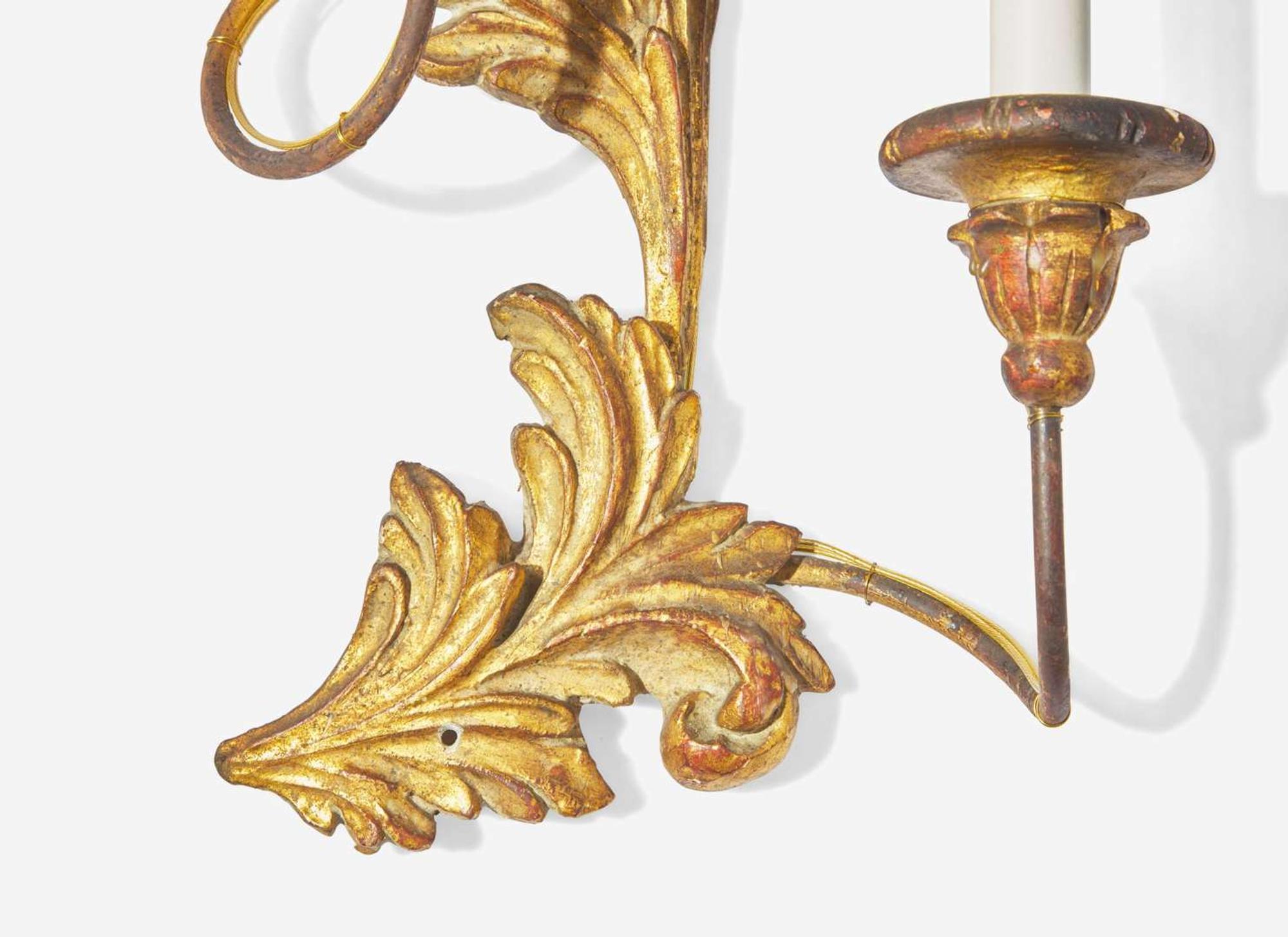A set of four Rococo style giltwood and metal three-light sconces, 20th century