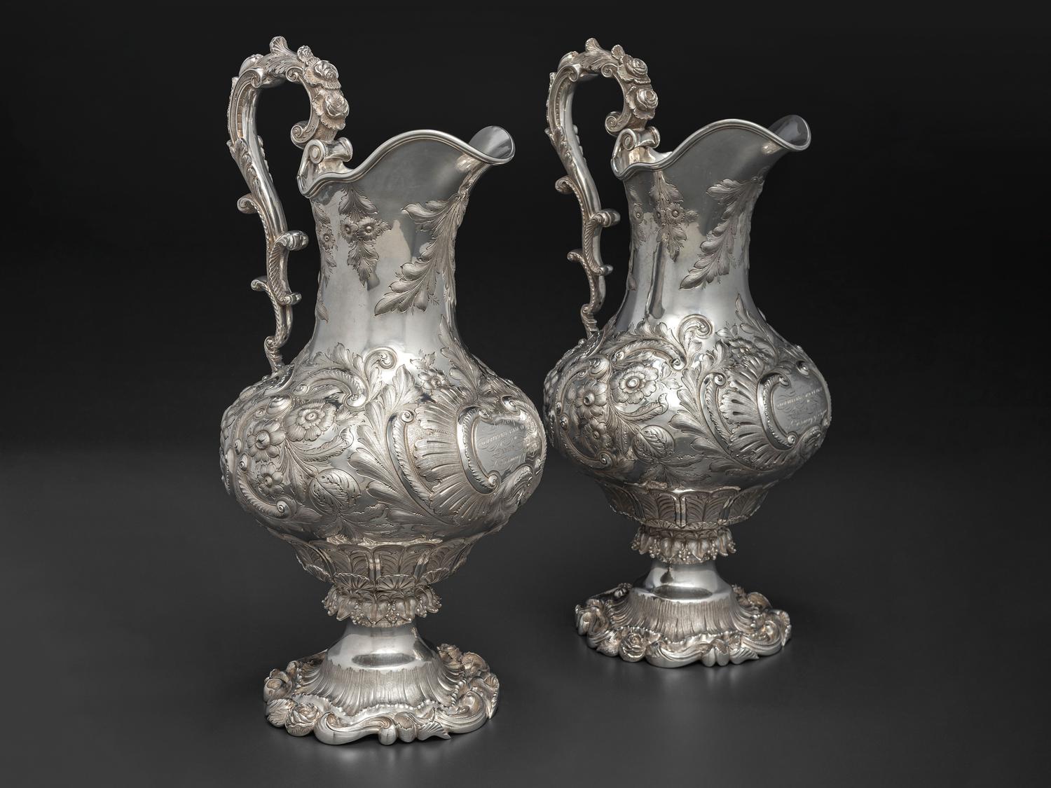 A Pair of American Repousse Silver Presentation Pitchers