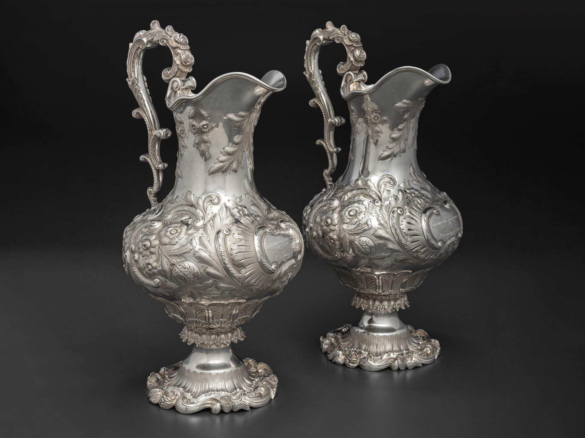 A Pair of American Repousse Silver Presentation Pitchers