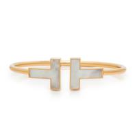 TIFFANY & CO., MOTHER-OF-PEARL AND YELLOW GOLD 'T' WIRE CUFF BRACELET