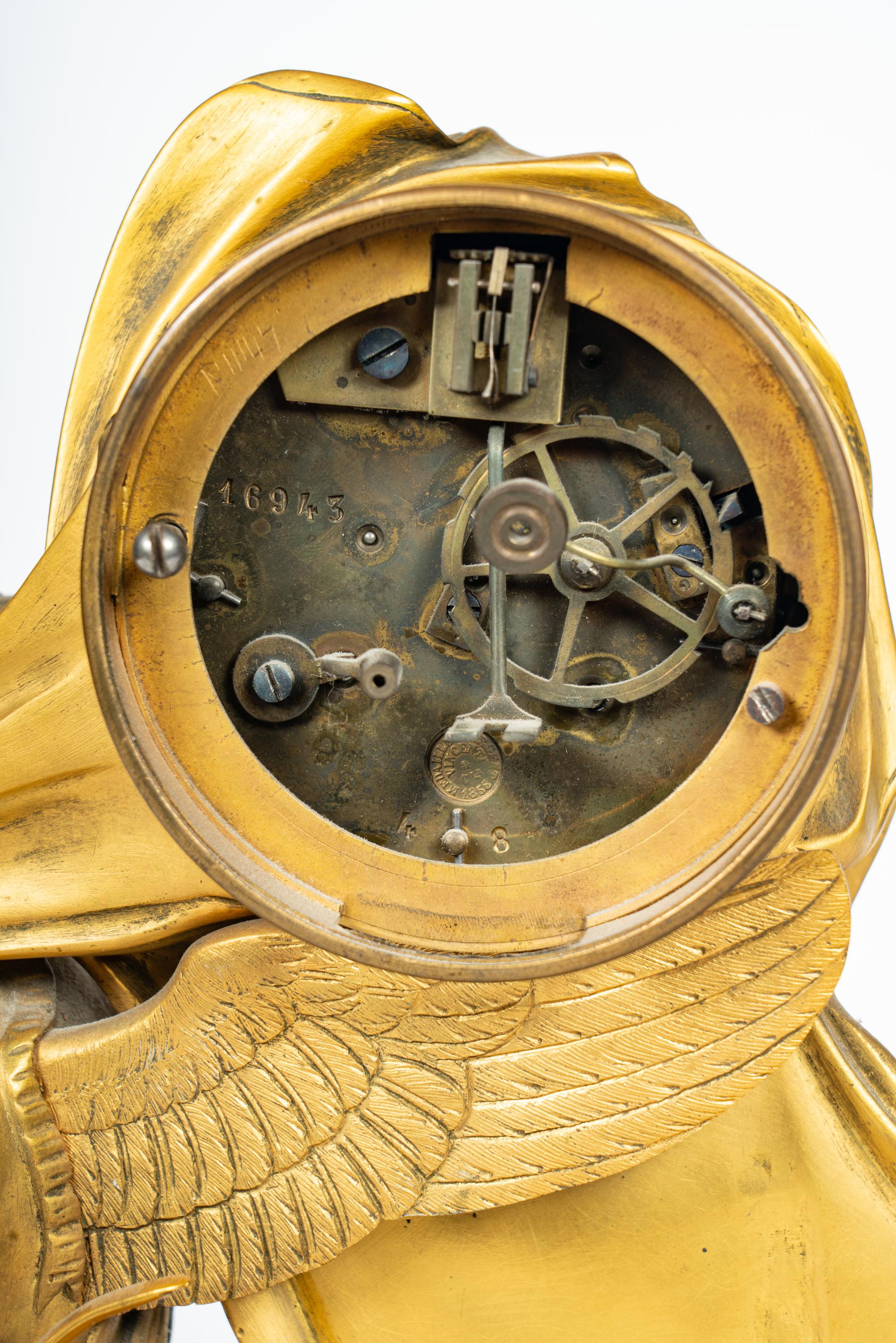 An Empire Style Gilt Bronze and Marble Figural Clock