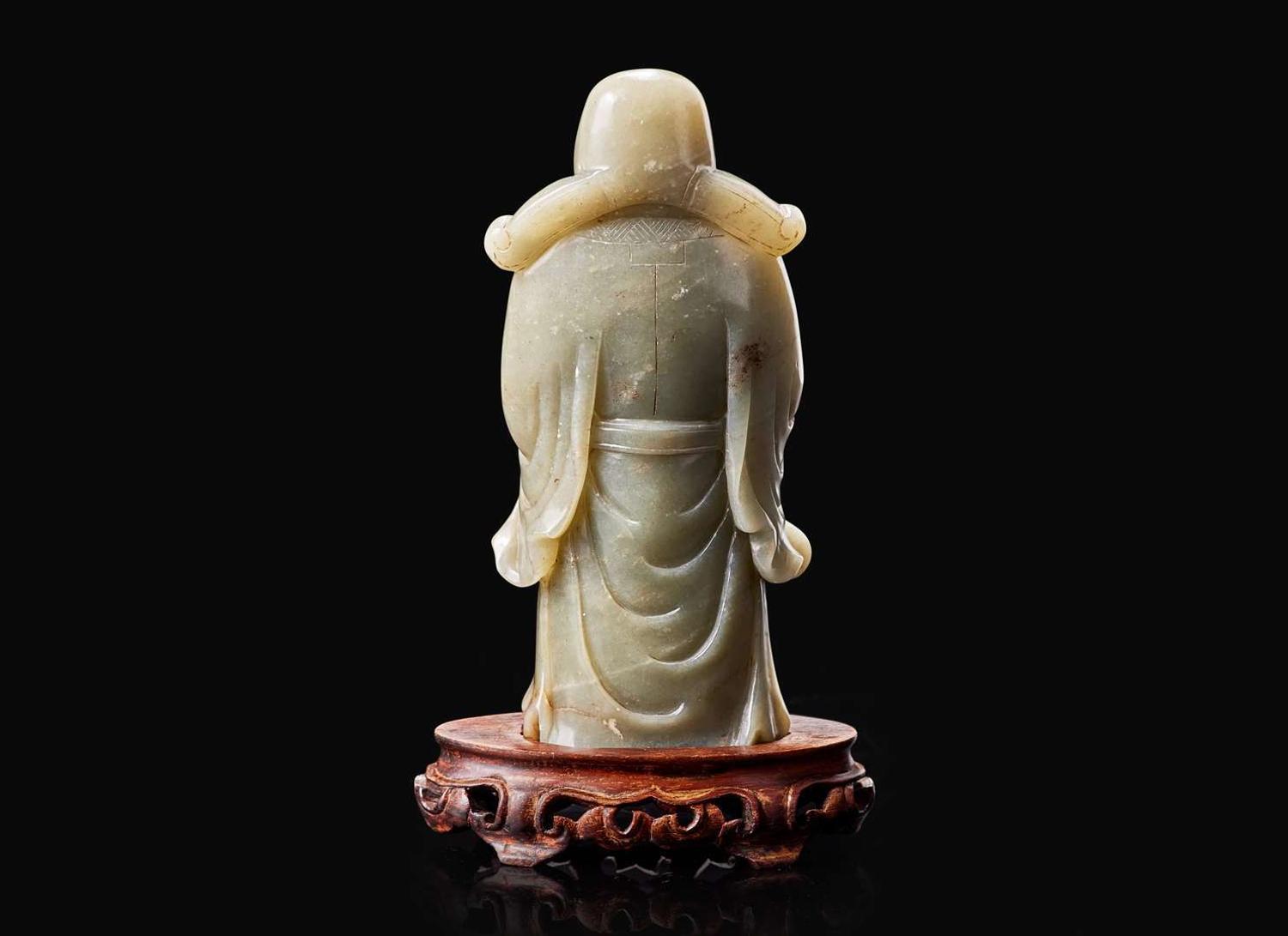 A Chinese carved celadon jade figure of a civil deity, possibly Caishen 青玉雕人物 可能為財神