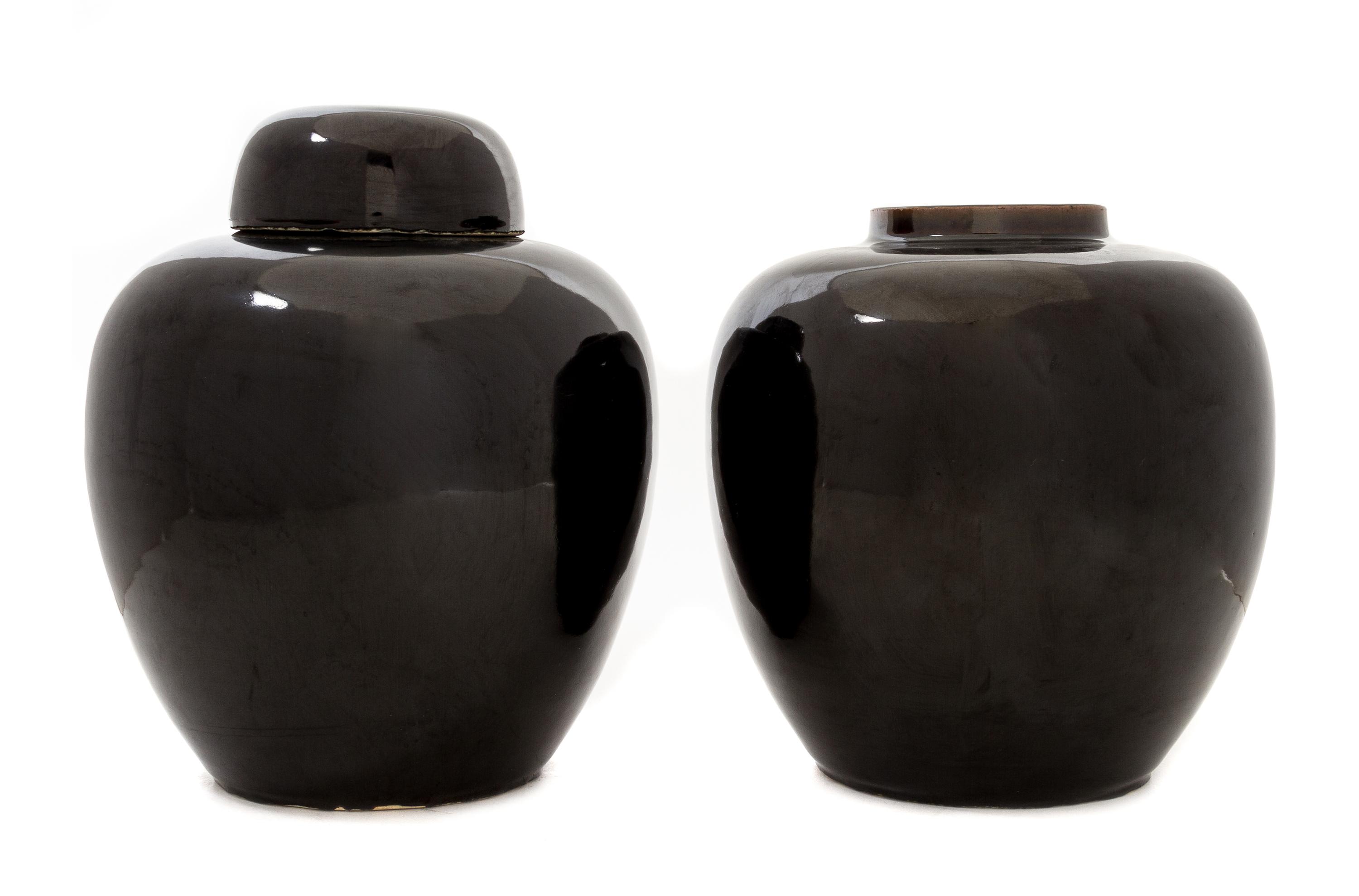 A Pair of Mirror Black Glazed Porcelain Ginger Jars Height 9 1/2 inches.